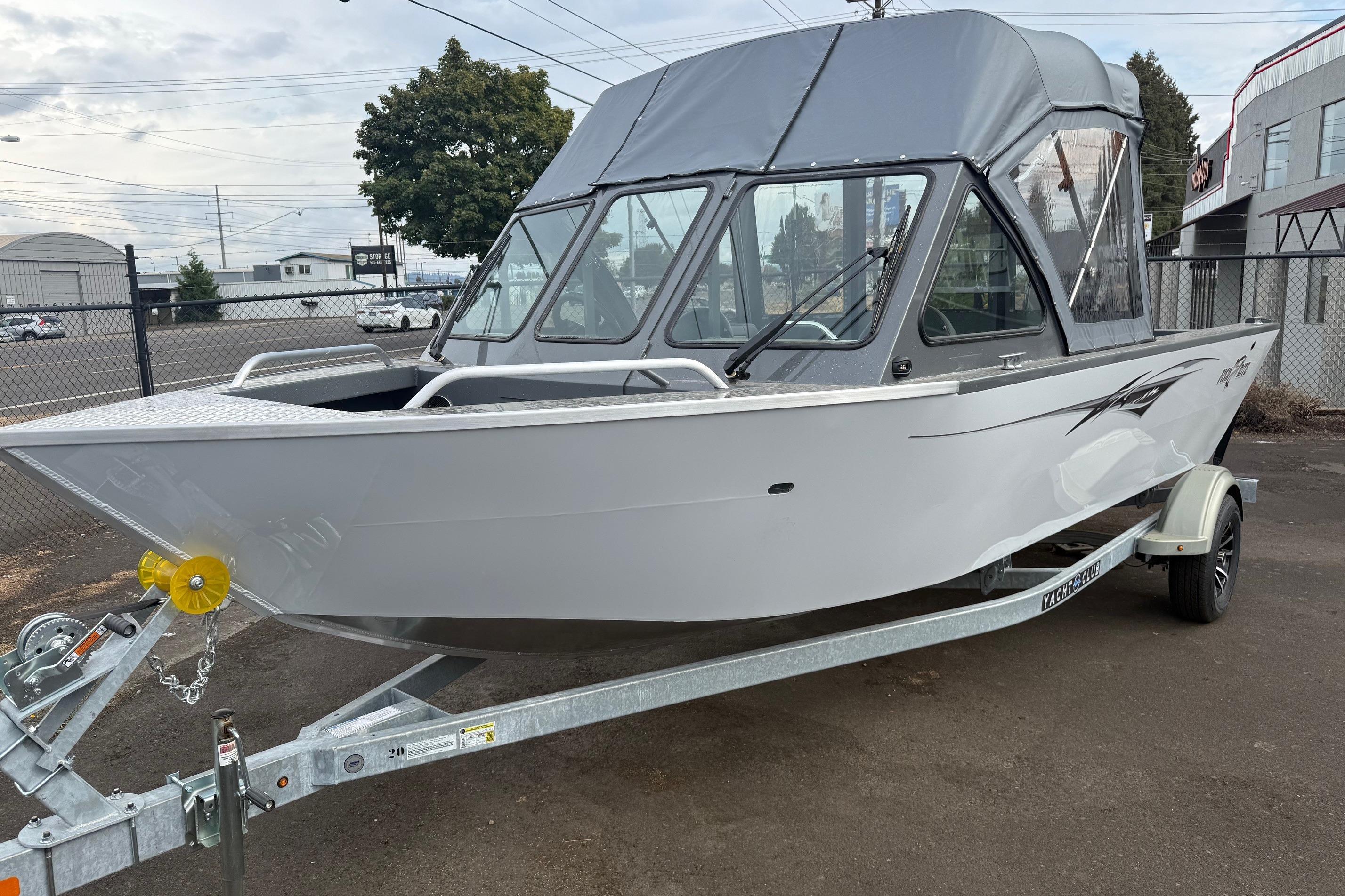 2026 Fish Rite Sportsman 20 boat on trailer, parked outdoors with canopy.