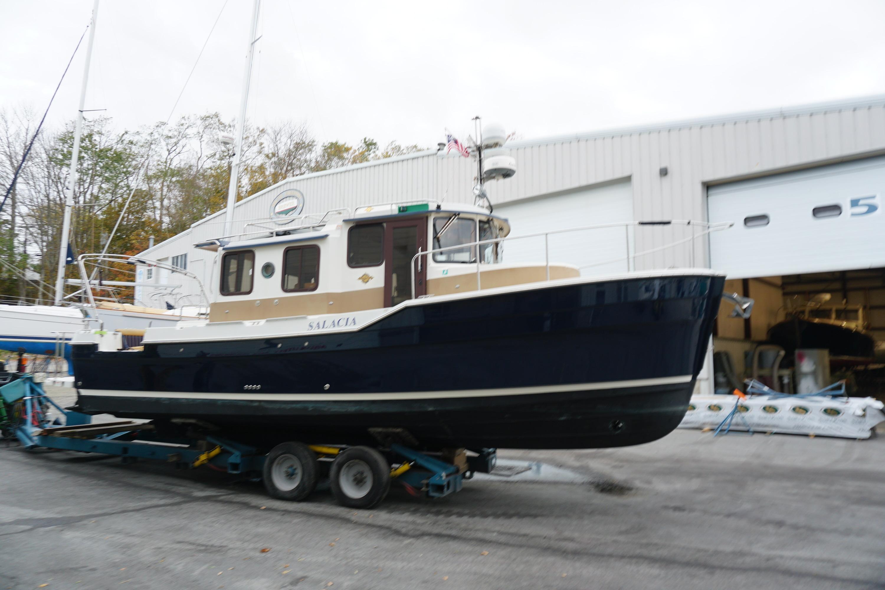 2013 Ranger Tugs S-31 boat on trailer outside a storage facility.