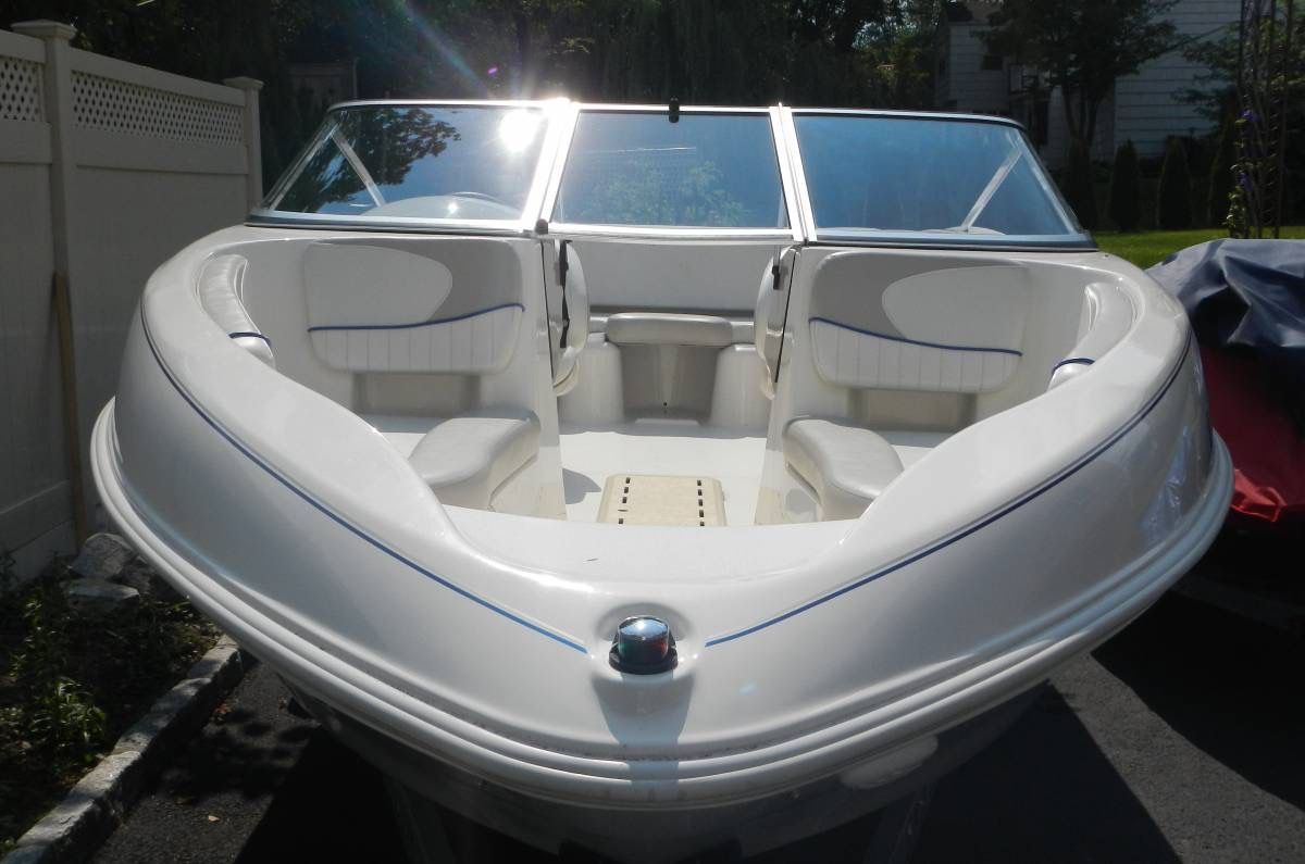 2006 Glastron MX-195 Limited Edition with a white hull and blue accents, parked on a trailer.