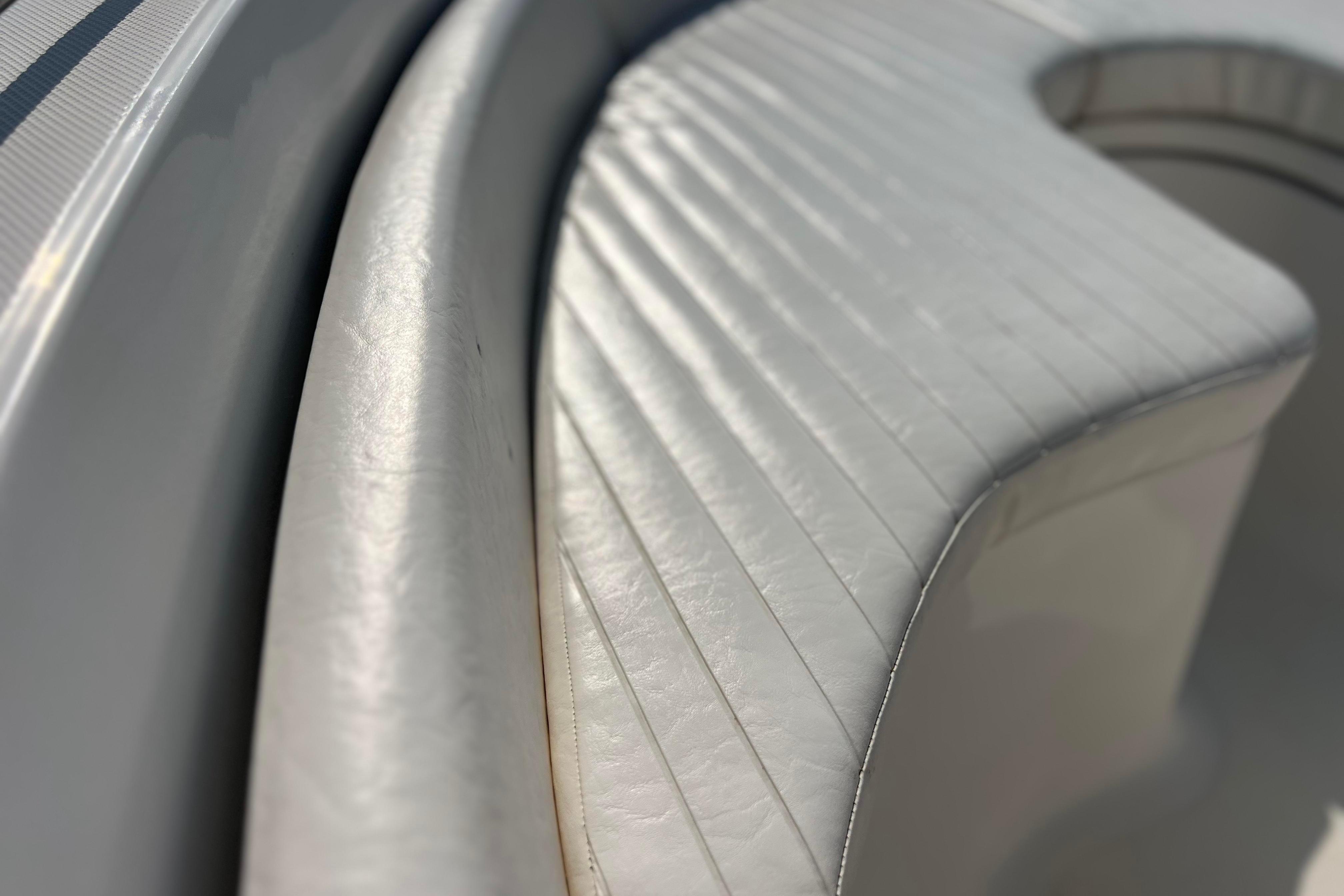 Close-up of 2012 Sea Fox 206 Center Console boat seating, showcasing white upholstery.
