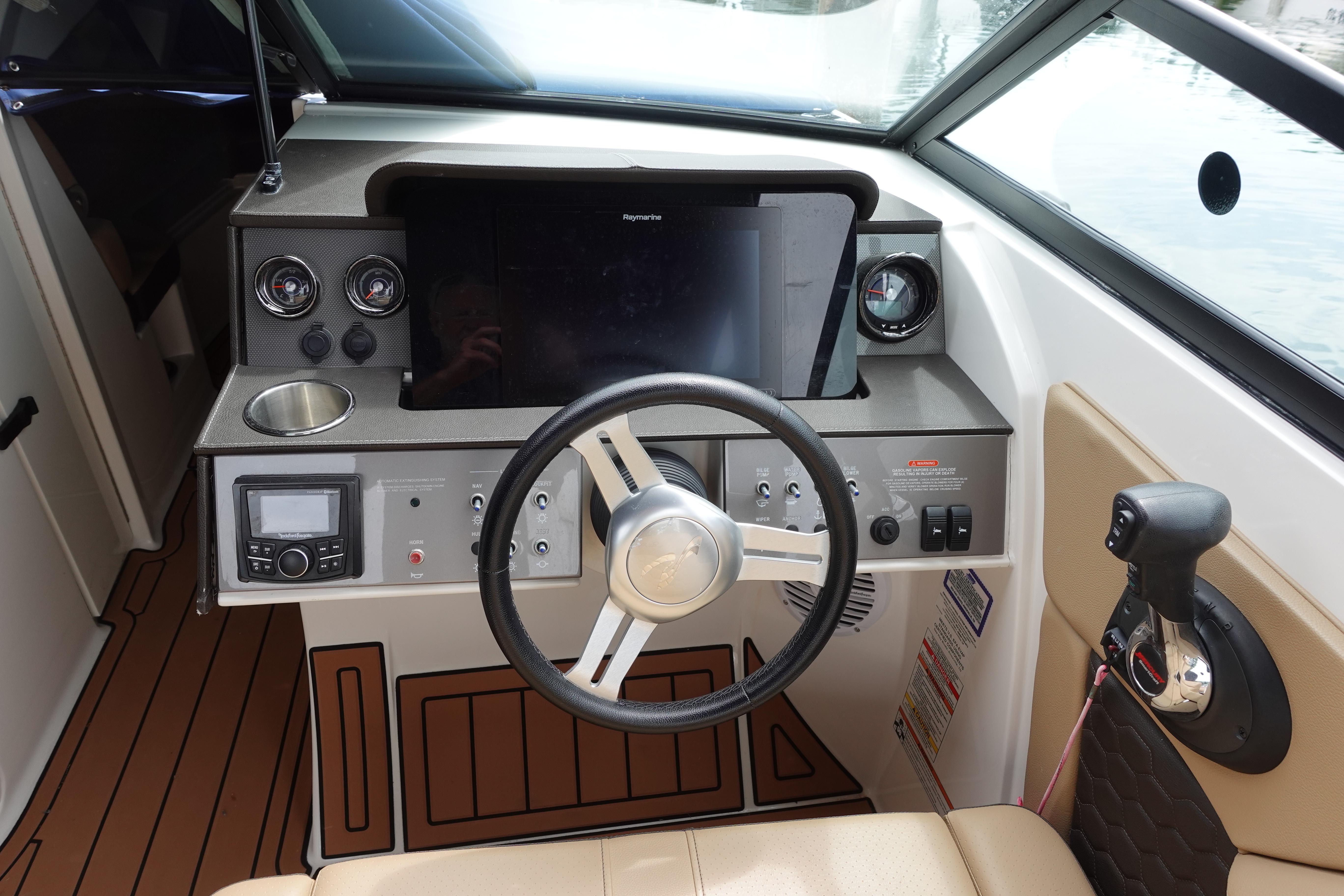 2018 Sea Ray SDX 270 helm with steering wheel, controls, and navigation display.