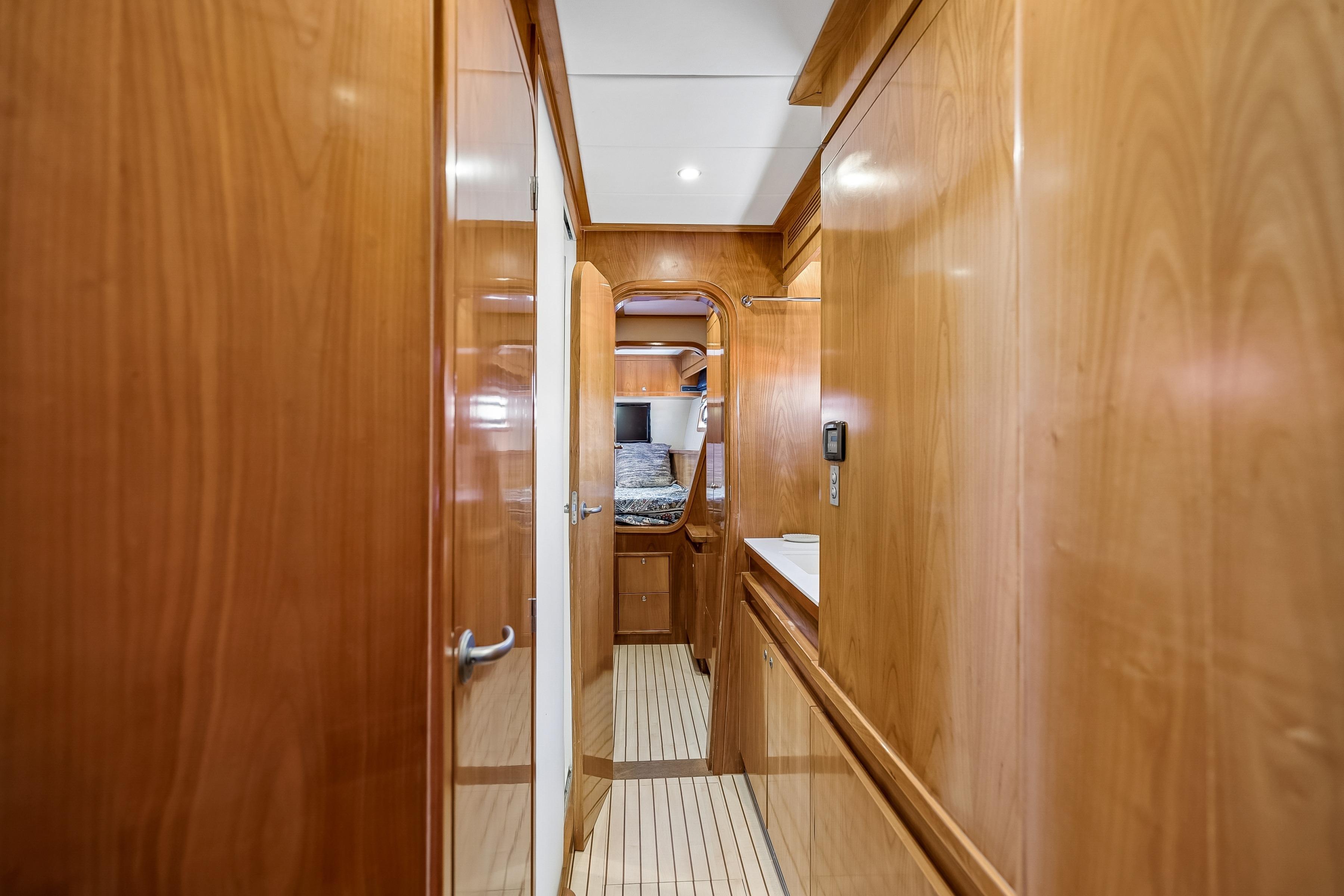 Interior hallway of 2009 Catana 65 yacht with wooden paneling and modern design.