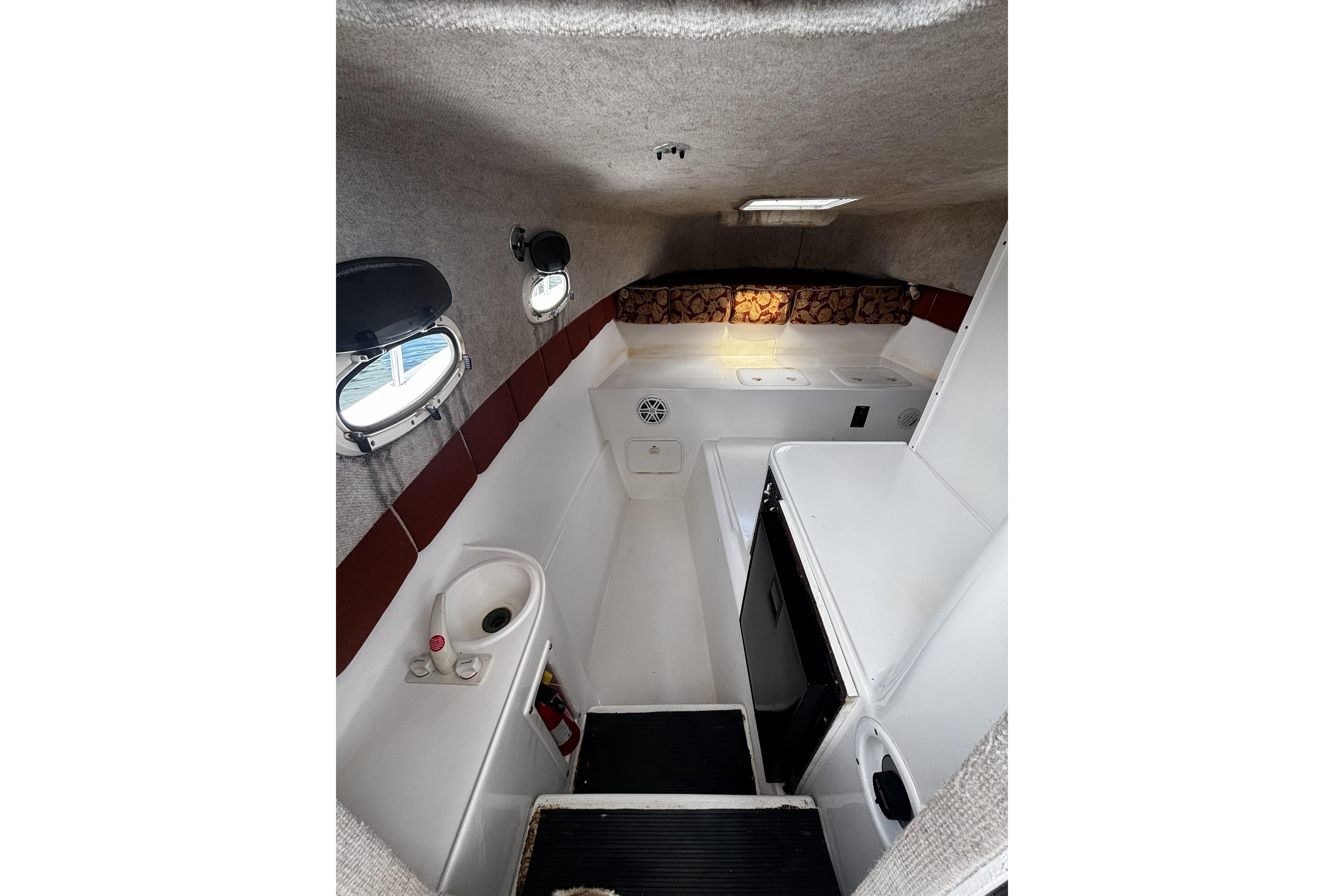 Interior of 2005 Prosports 2860 KATWA boat, featuring compact cabin amenities.