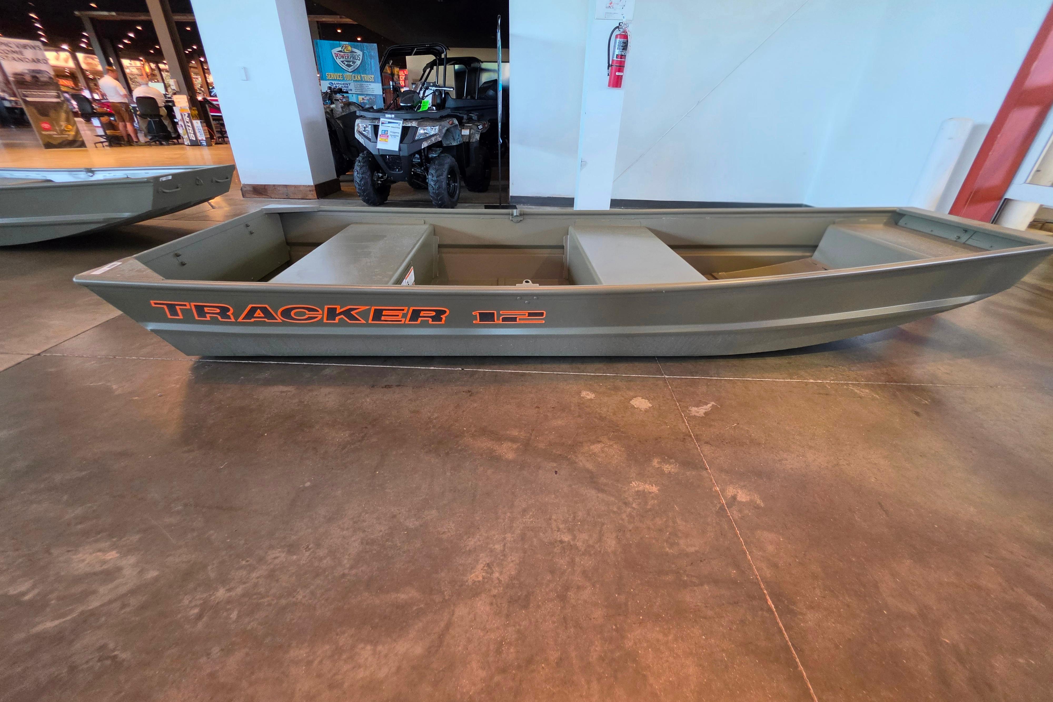 2026 Tracker Grizzly 12 Jon boat displayed indoors on concrete floor.