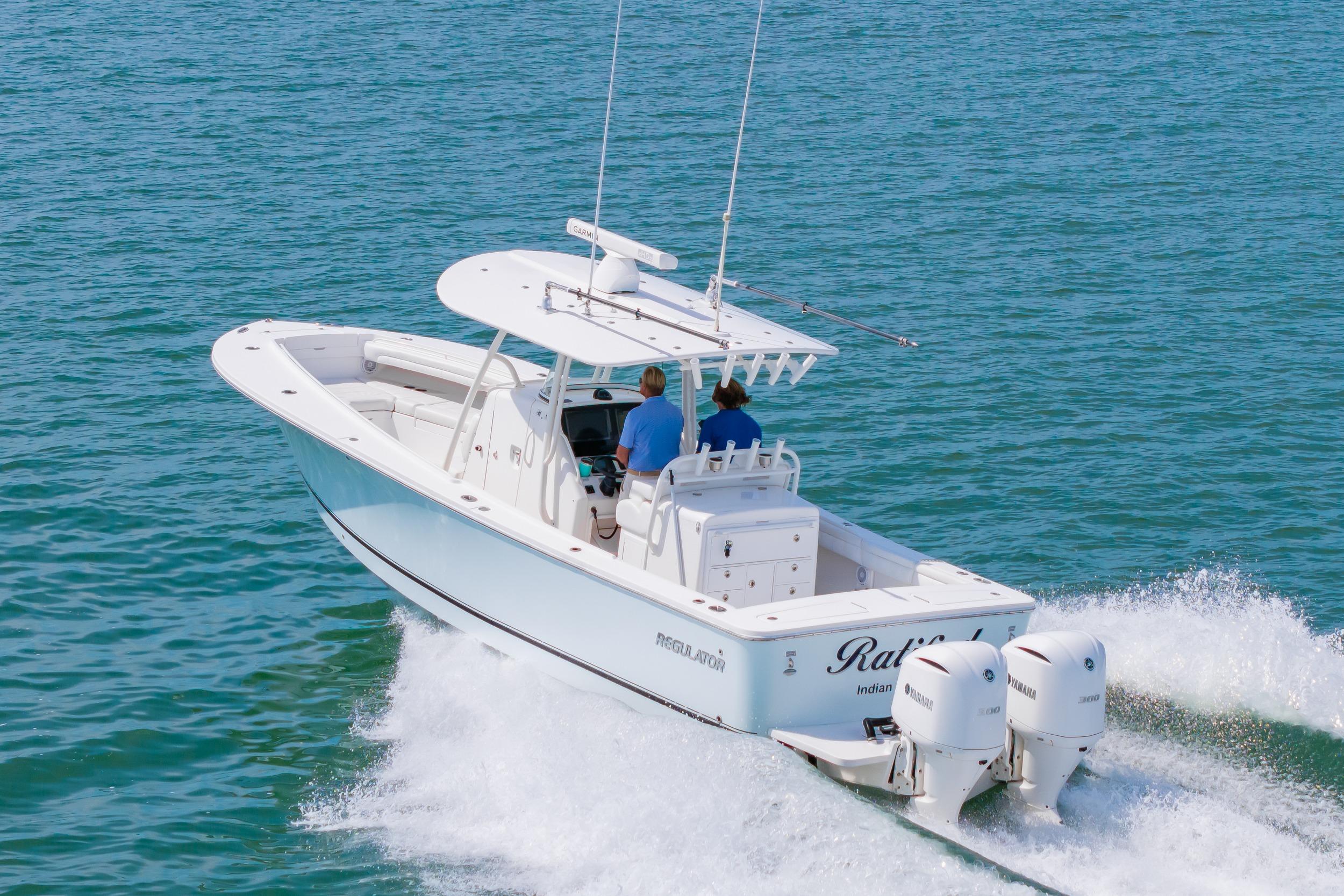 2019 Regulator 31 boat cruising on open water with twin engines.