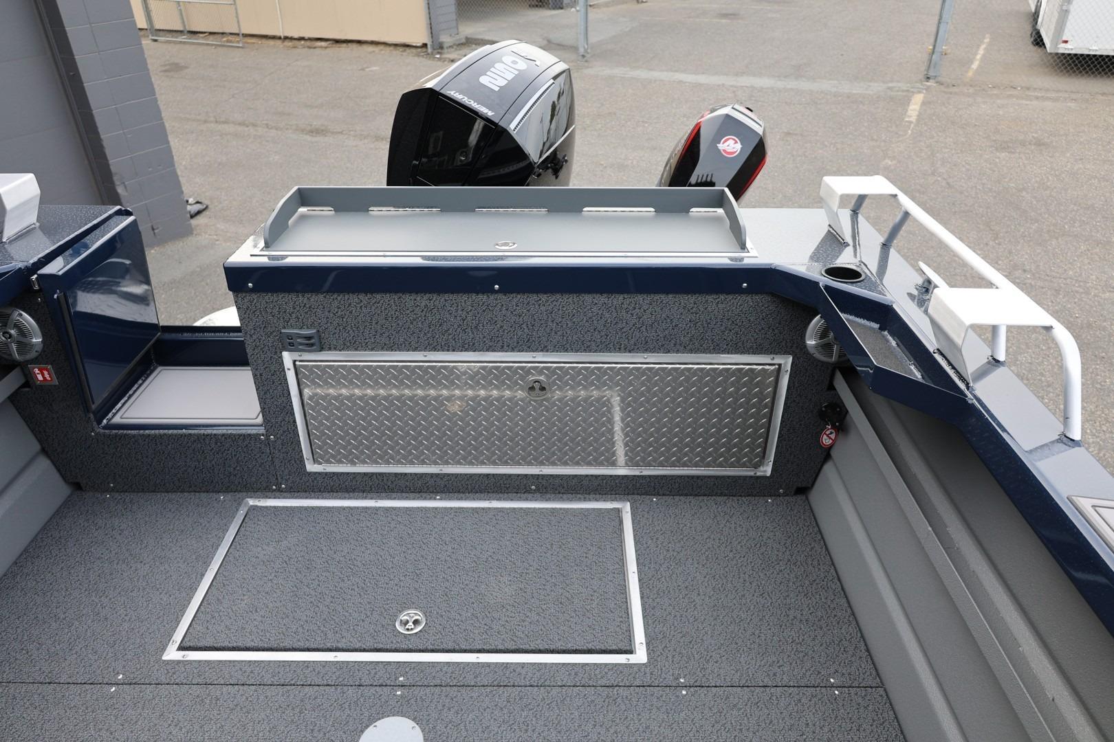 2026 Thunder Jet 24 Alexis Pro boat interior with storage and motor view.