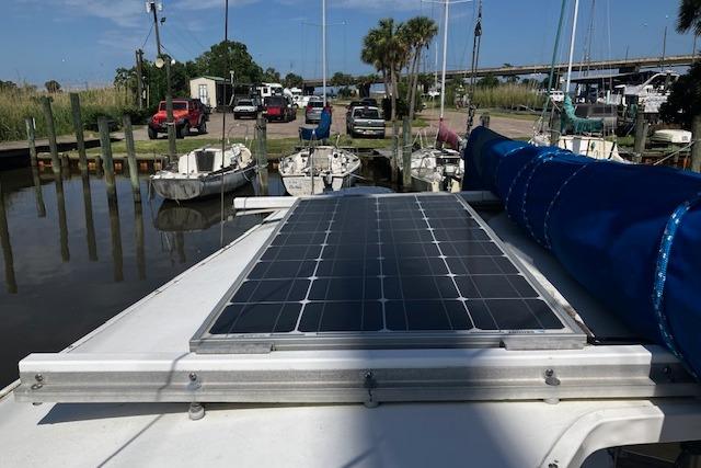 1979 Pearson 365 Ketch with solar panel docked at marina.
