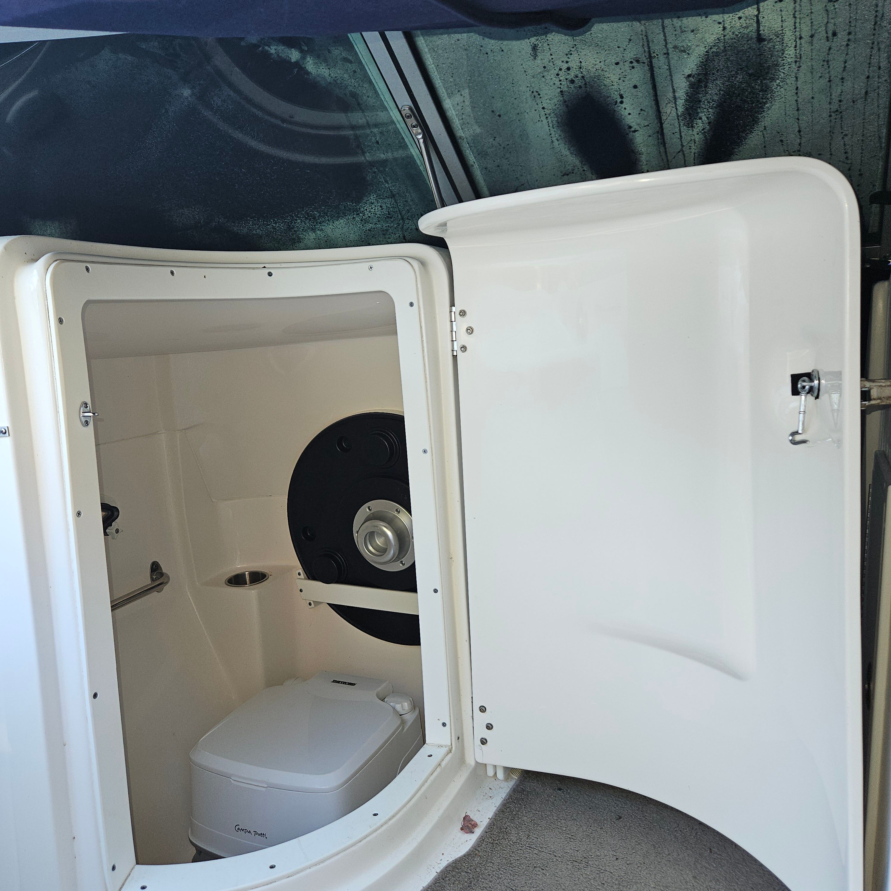 Interior of a 2009 Rinker Captiva DB with toilet.