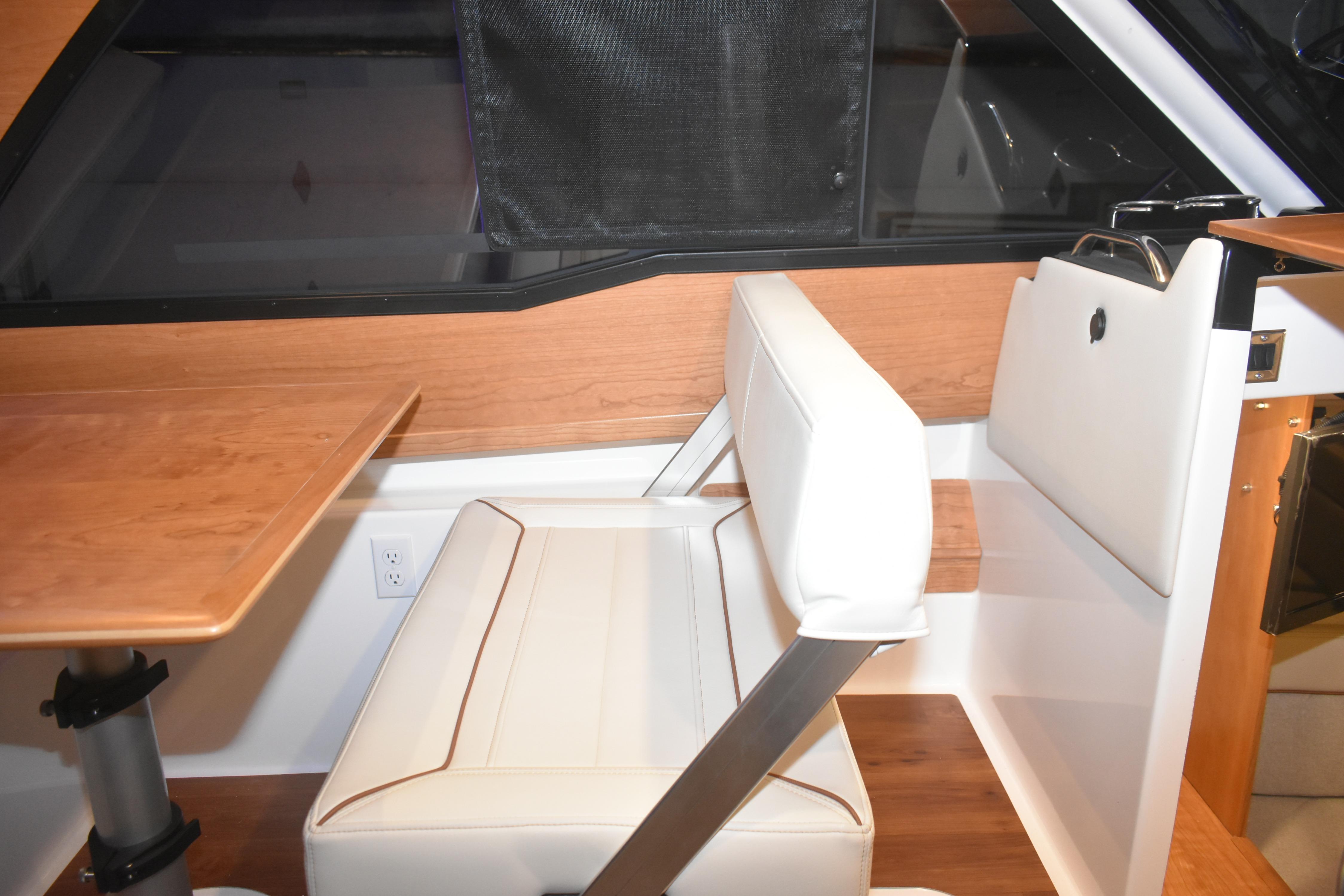 Interior of 2026 Cutwater C-248 Coupe featuring a modern seating area and wooden table.