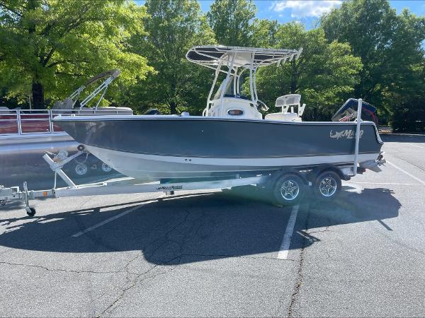 2024 Mako 214 CC boat on a trailer in a parking lot.