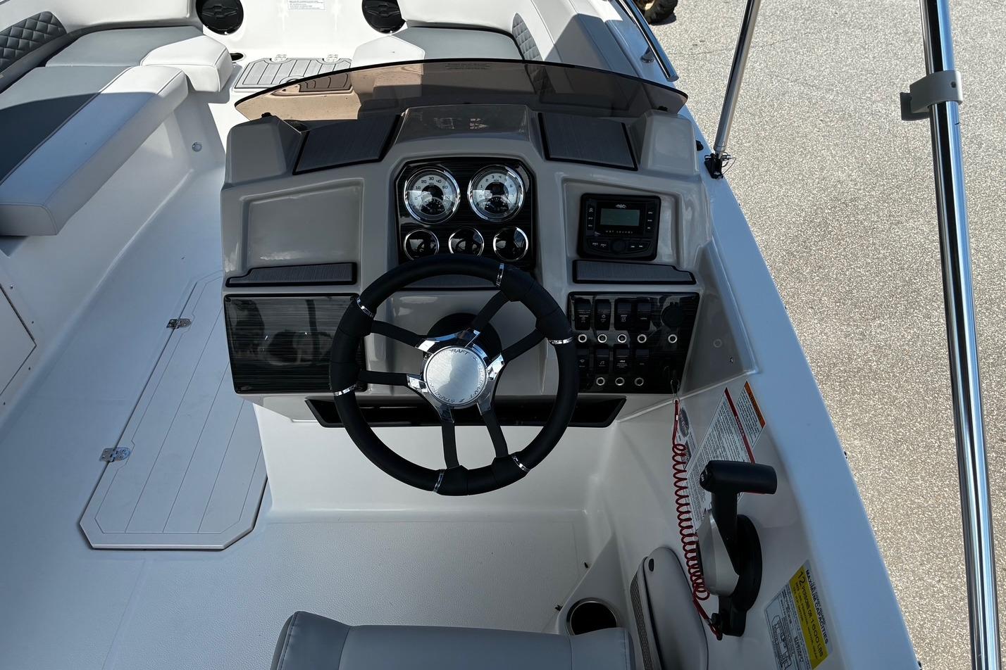 2026 Starcraft SVX 191 OB boat dashboard with steering wheel and control panel.