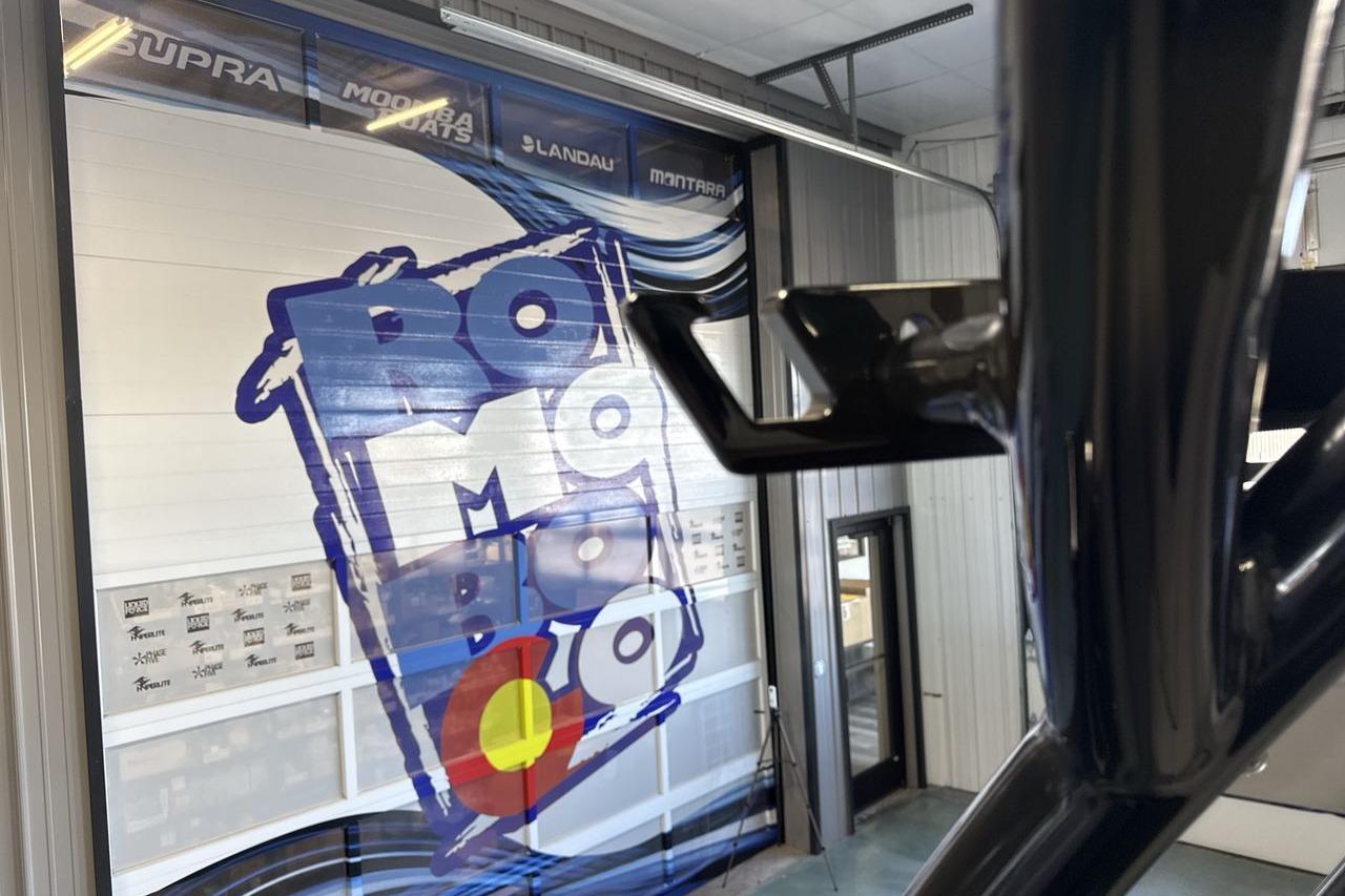 2026 Moomba Tykon boat showroom with vibrant wall graphics and sleek design elements.
