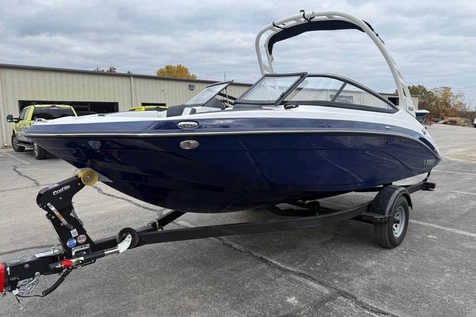 2026 Yamaha Boats 195S on trailer, parked outdoors near industrial building.