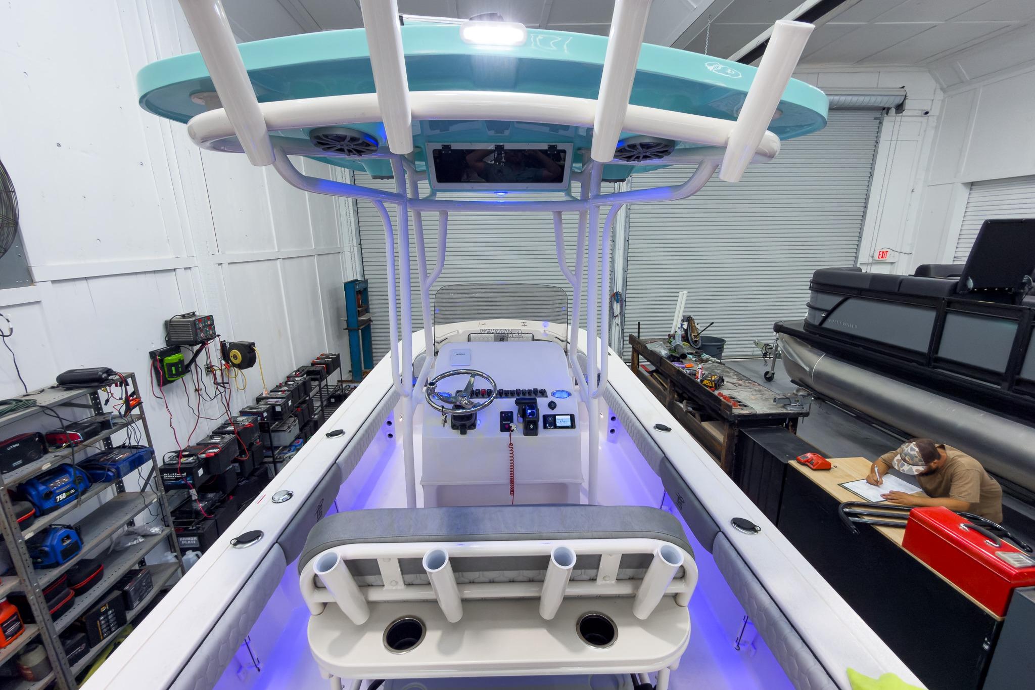 Interior view of a 2026 Carolina Skiff 24 Ultra Elite boat in a workshop.