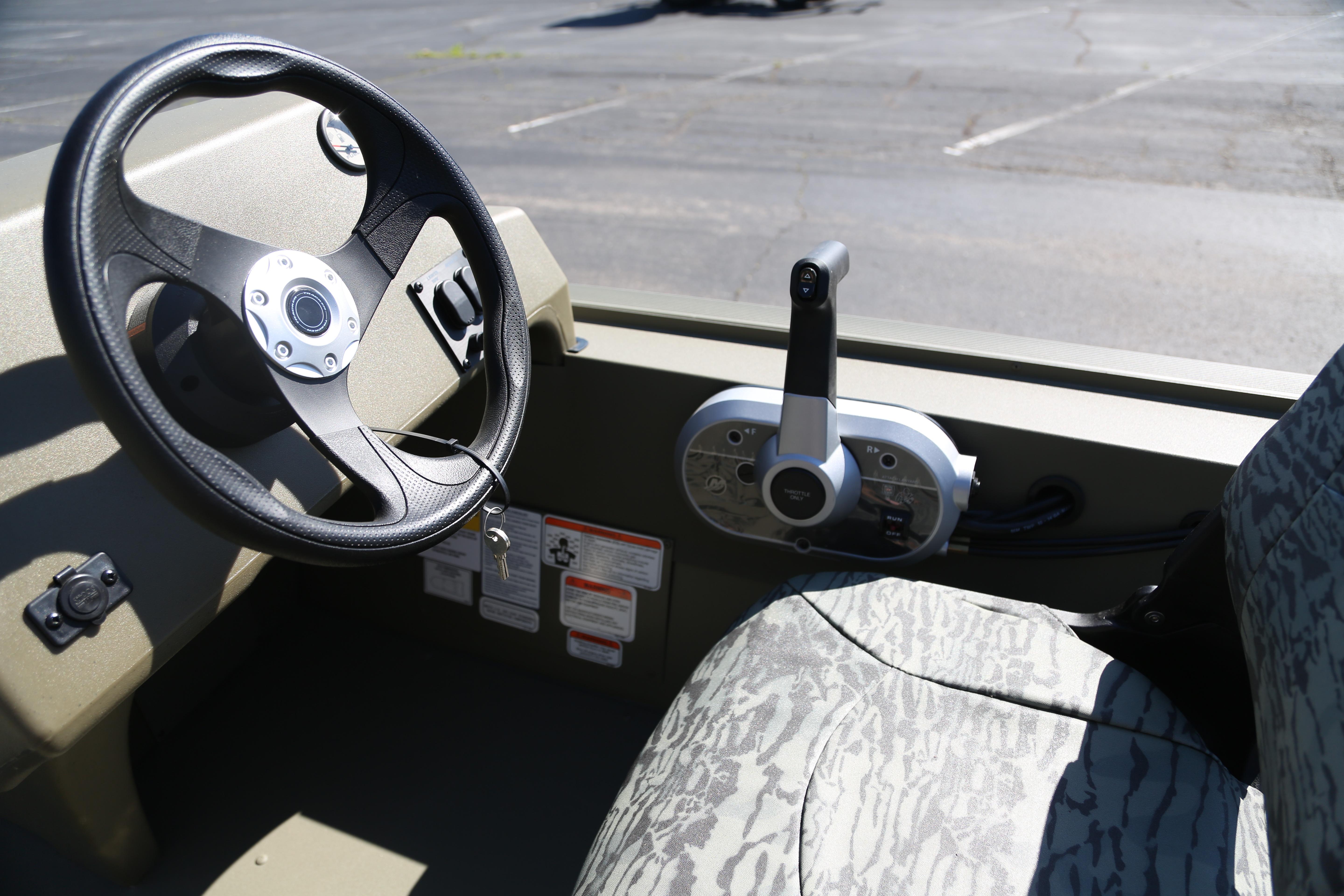2026 Tracker Grizzly 1754 SC boat interior with steering wheel and control panel.