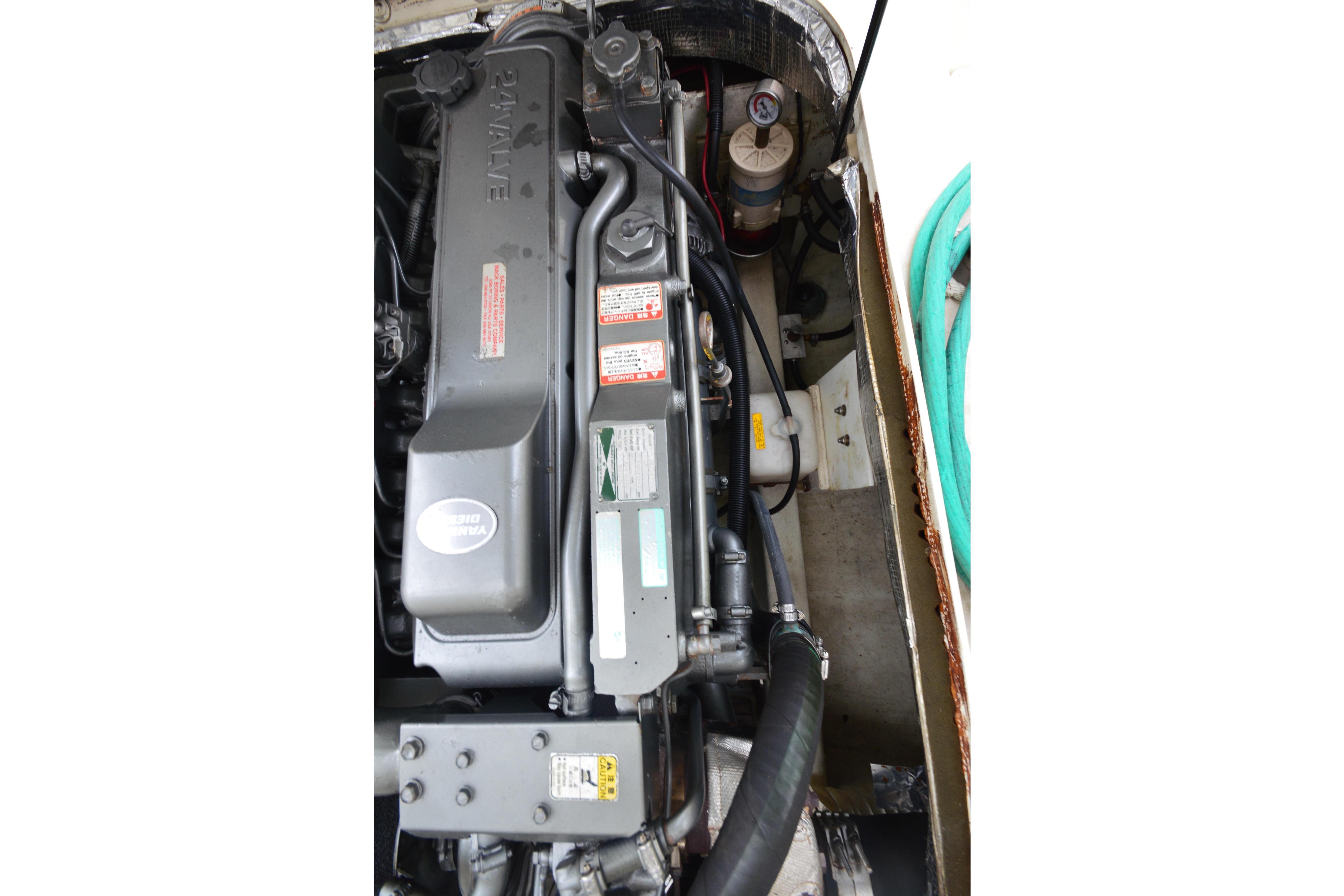 Engine compartment of a 2001 Albin 28 Tournament Express with visible hoses and components.