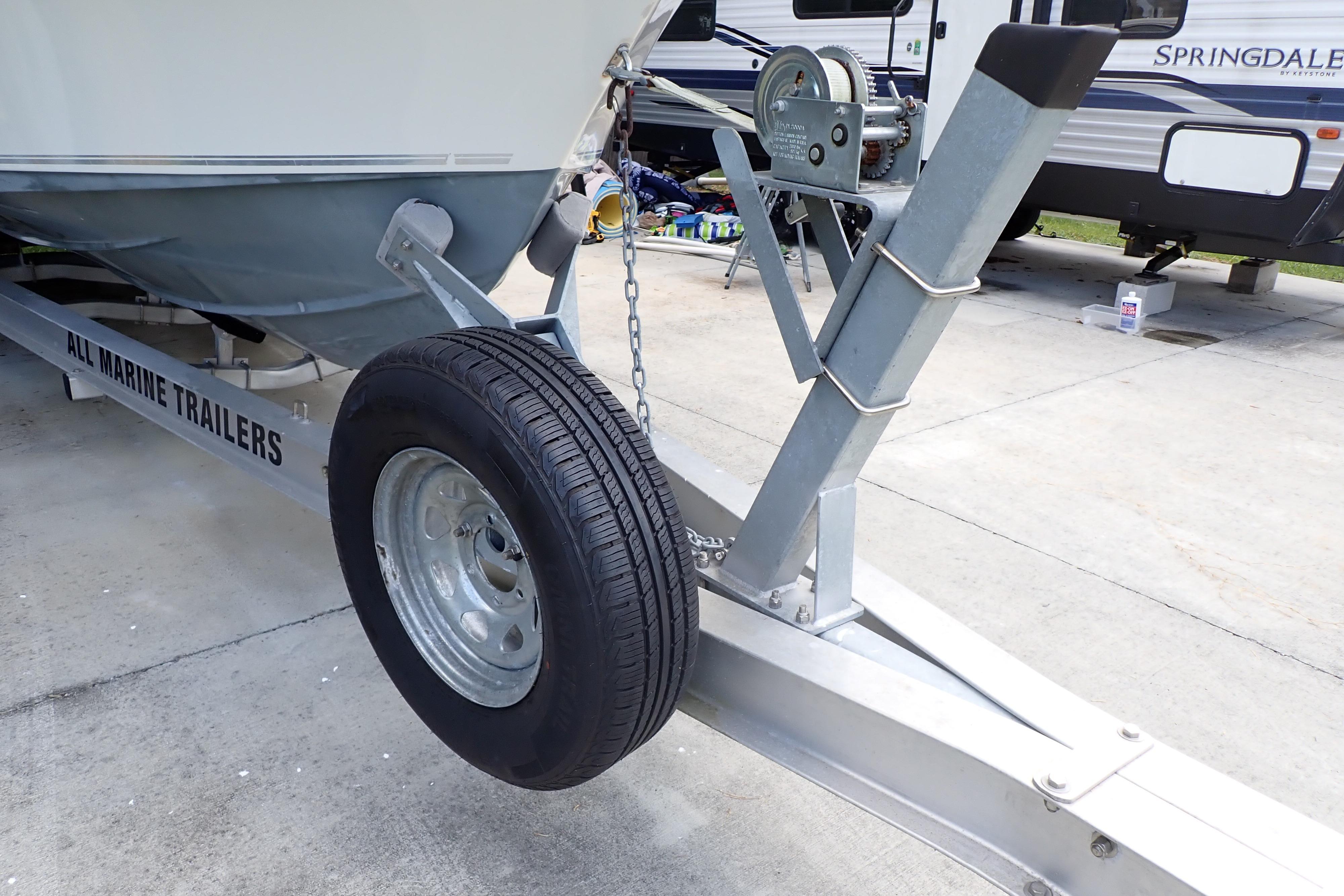 2019 Key West 263 FS boat on All Marine Trailers, featuring a sturdy wheel and hitch.