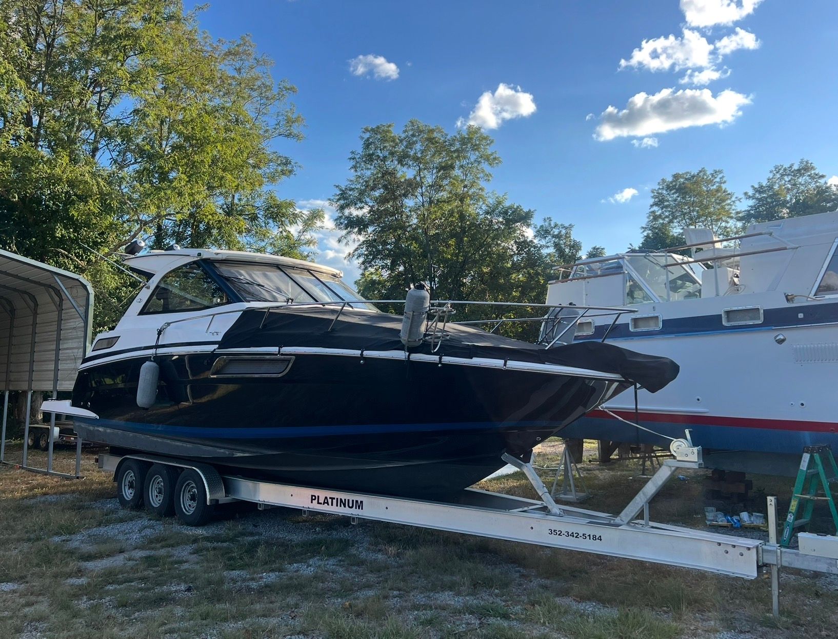2015 Regal 35 Sport Coupe on trailer, blue sky.