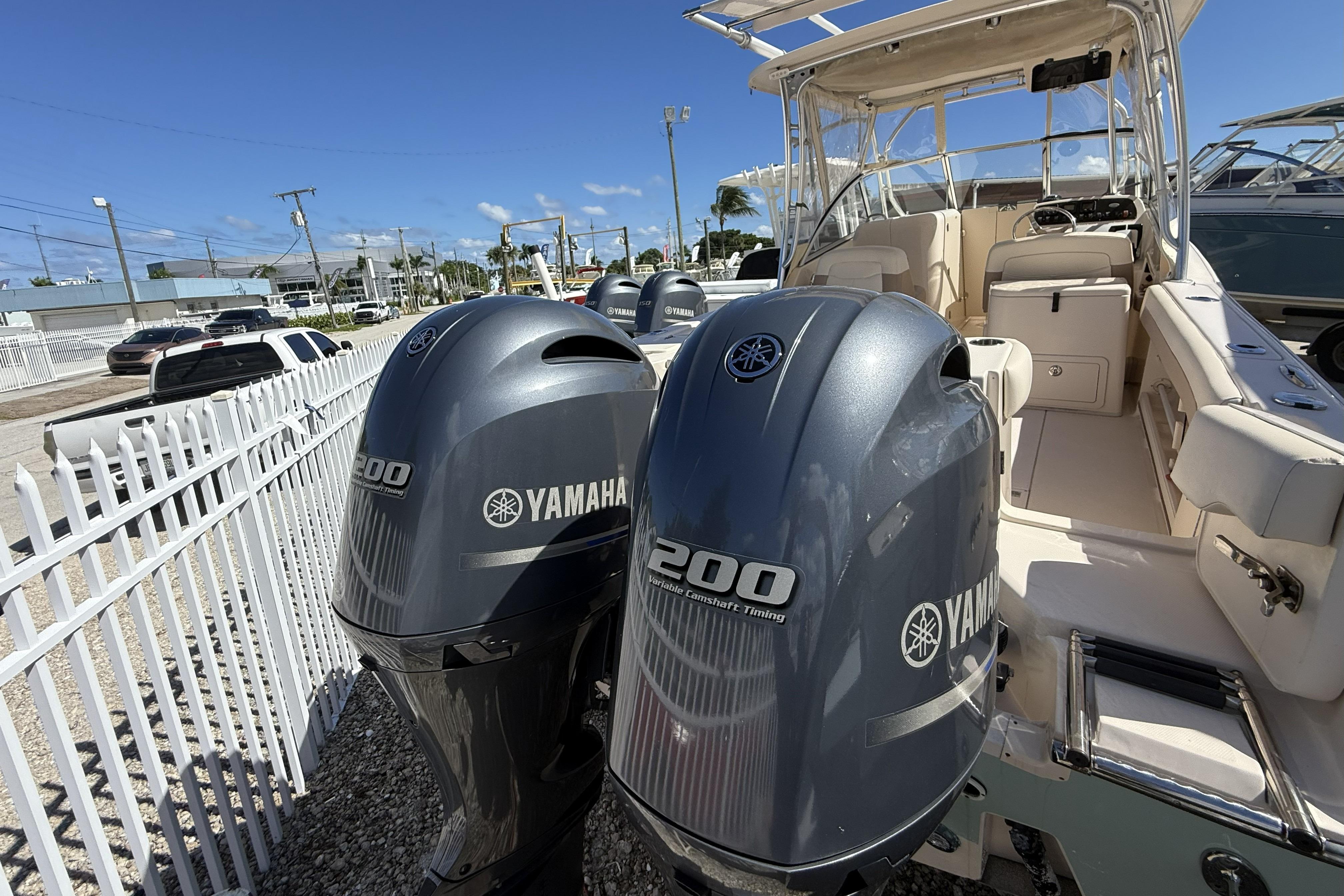 2014 Grady-White Freedom 275 boat with twin Yamaha 200 engines, docked outdoors.