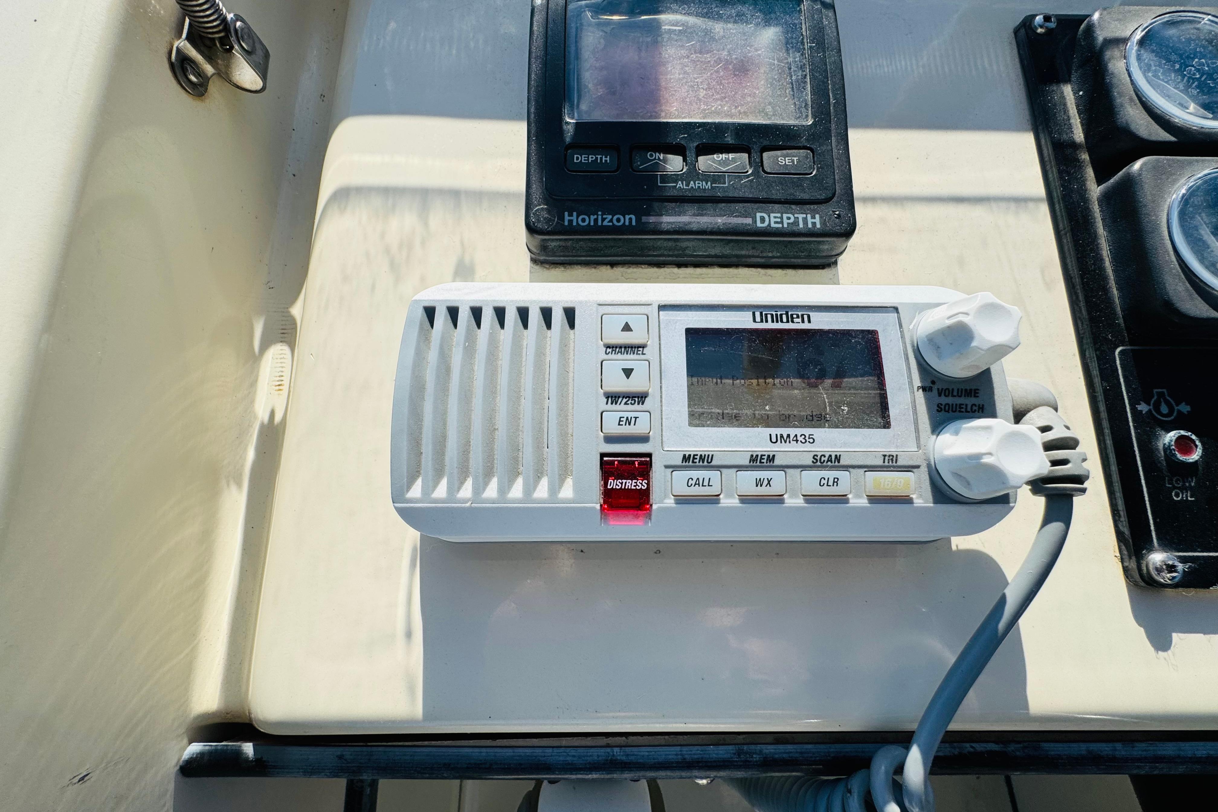 Uniden UM435 radio and depth gauge on 1996 Nordic Tug 32 dashboard.