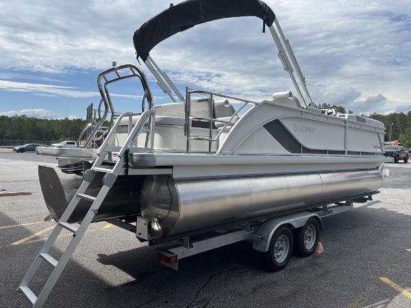2025 Godfrey SWEETWATER 2286 SFL pontoon boat on trailer, parked outdoors.