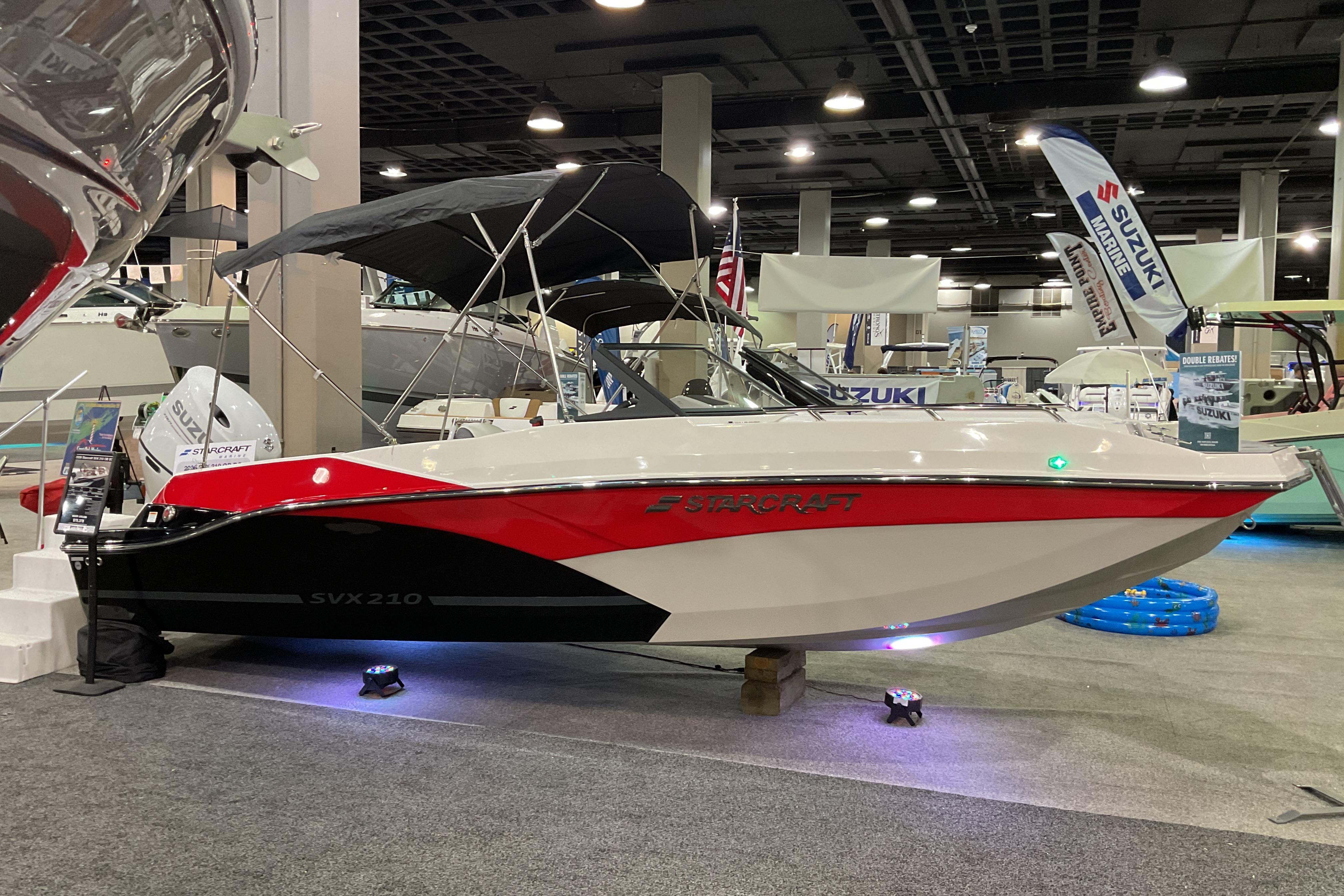 2026 Starcraft SVX 210 DC OB boat displayed at an indoor exhibition.