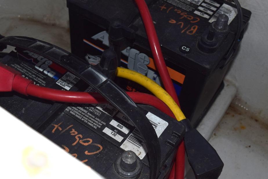 Battery setup in a 2006 Cobalt 240 with red and yellow cables.