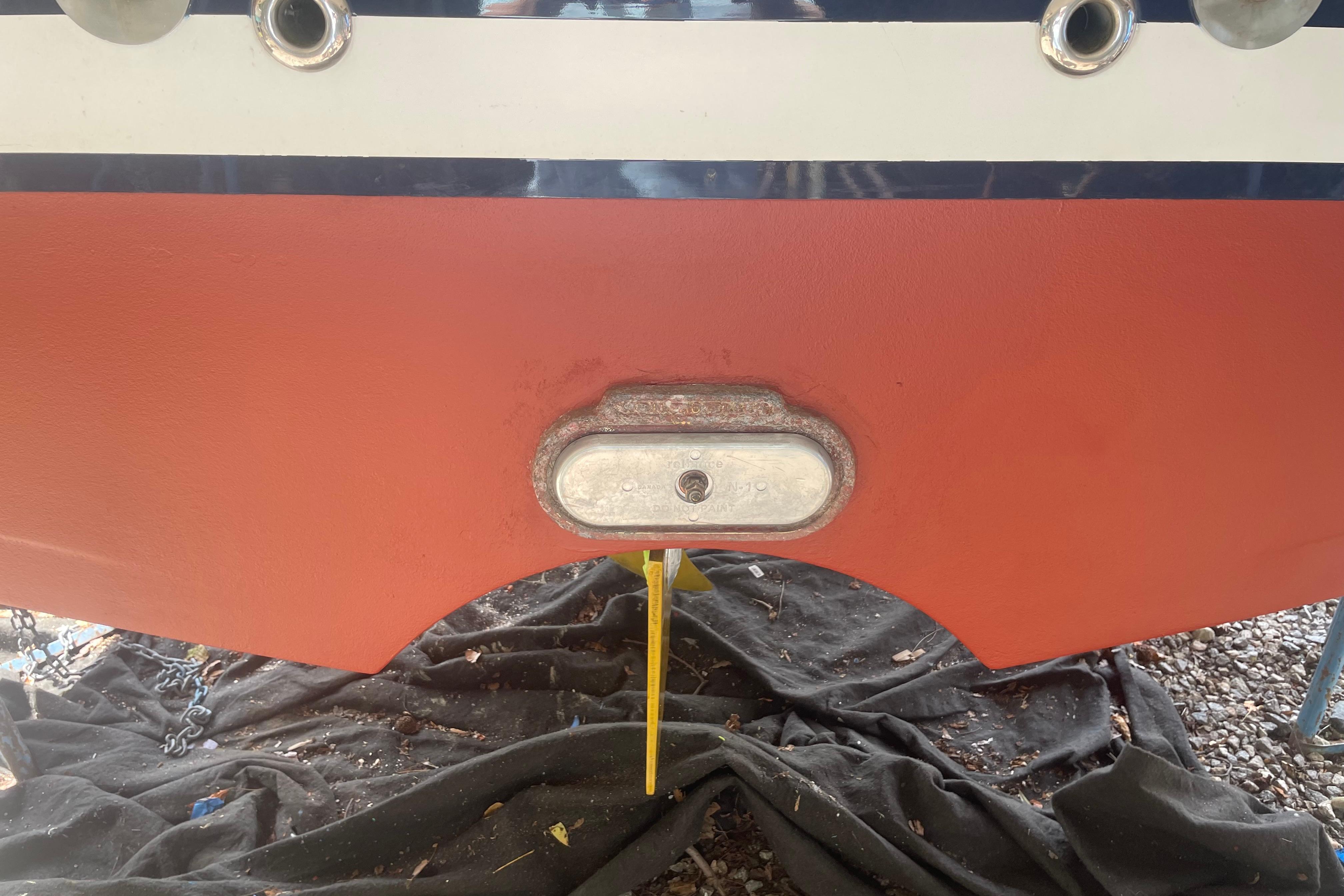 2007 Back Cove 29 boat hull with drain plug and red bottom paint.