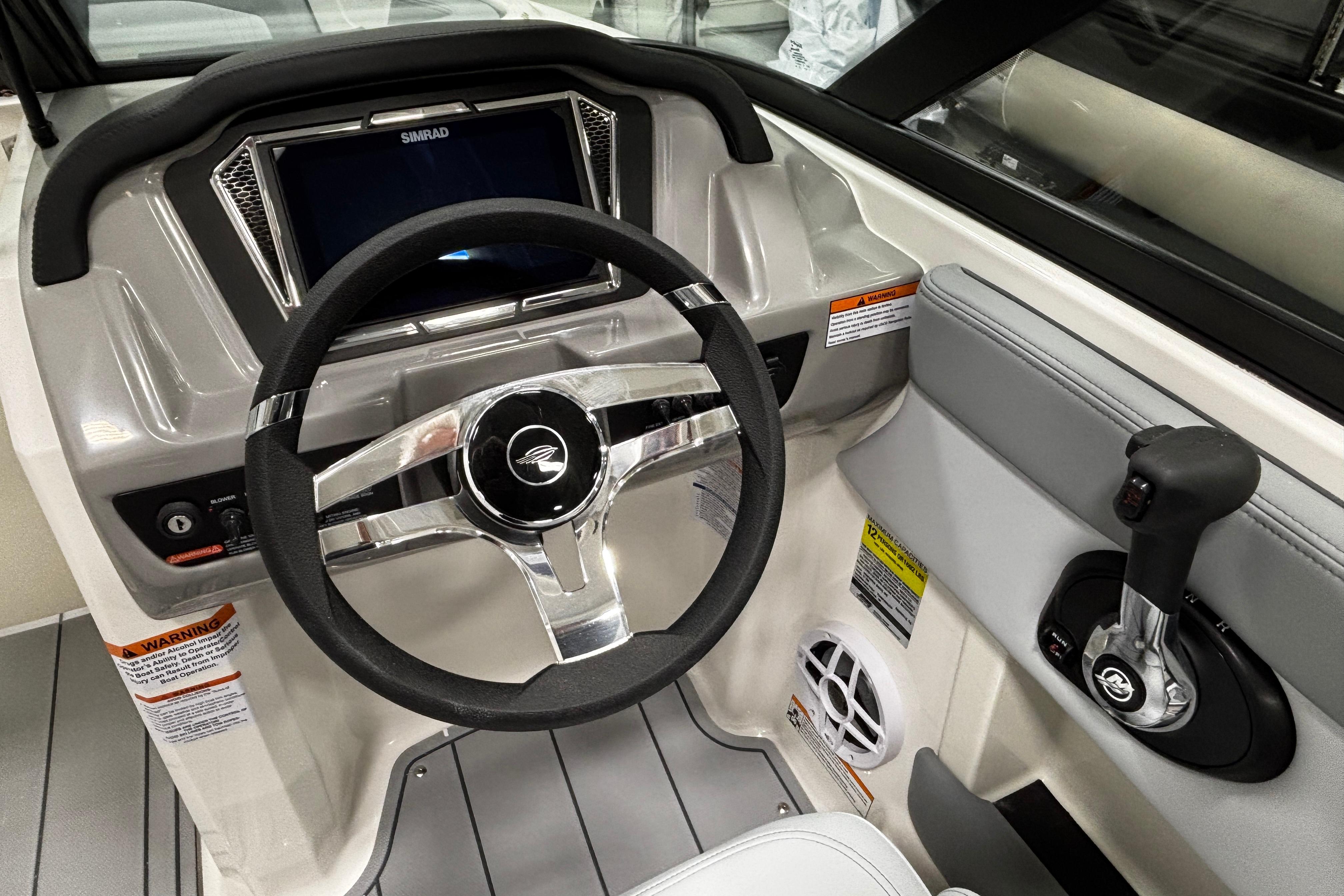 2026 Chaparral 21 SSi boat dashboard with steering wheel and control panel.