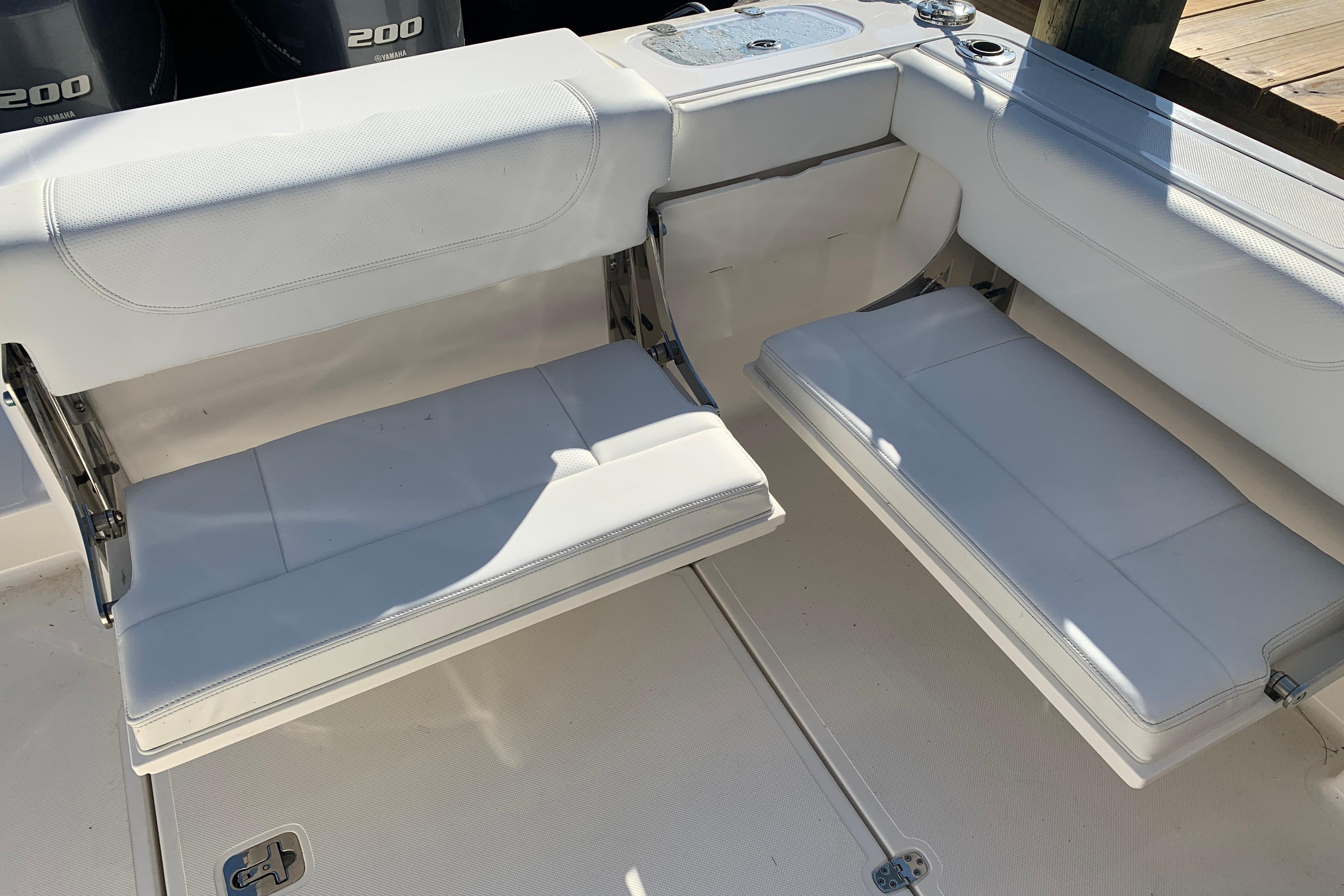 2023 Pursuit DC 266 Dual Console boat seating area with white cushioned seats.