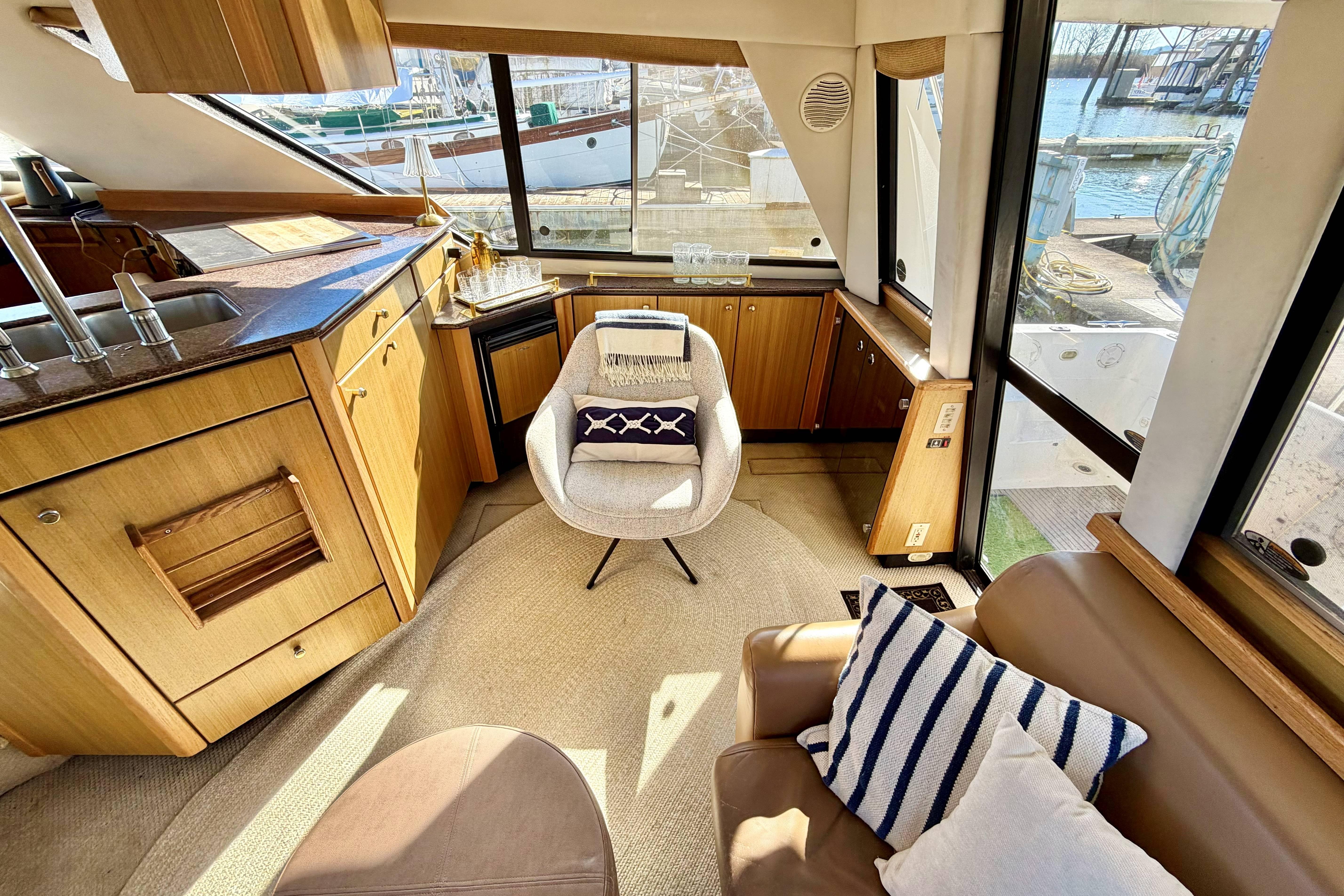 Interior of 2002 Bayliner 3988 Command Bridge Motoryacht with modern furnishings and kitchen.