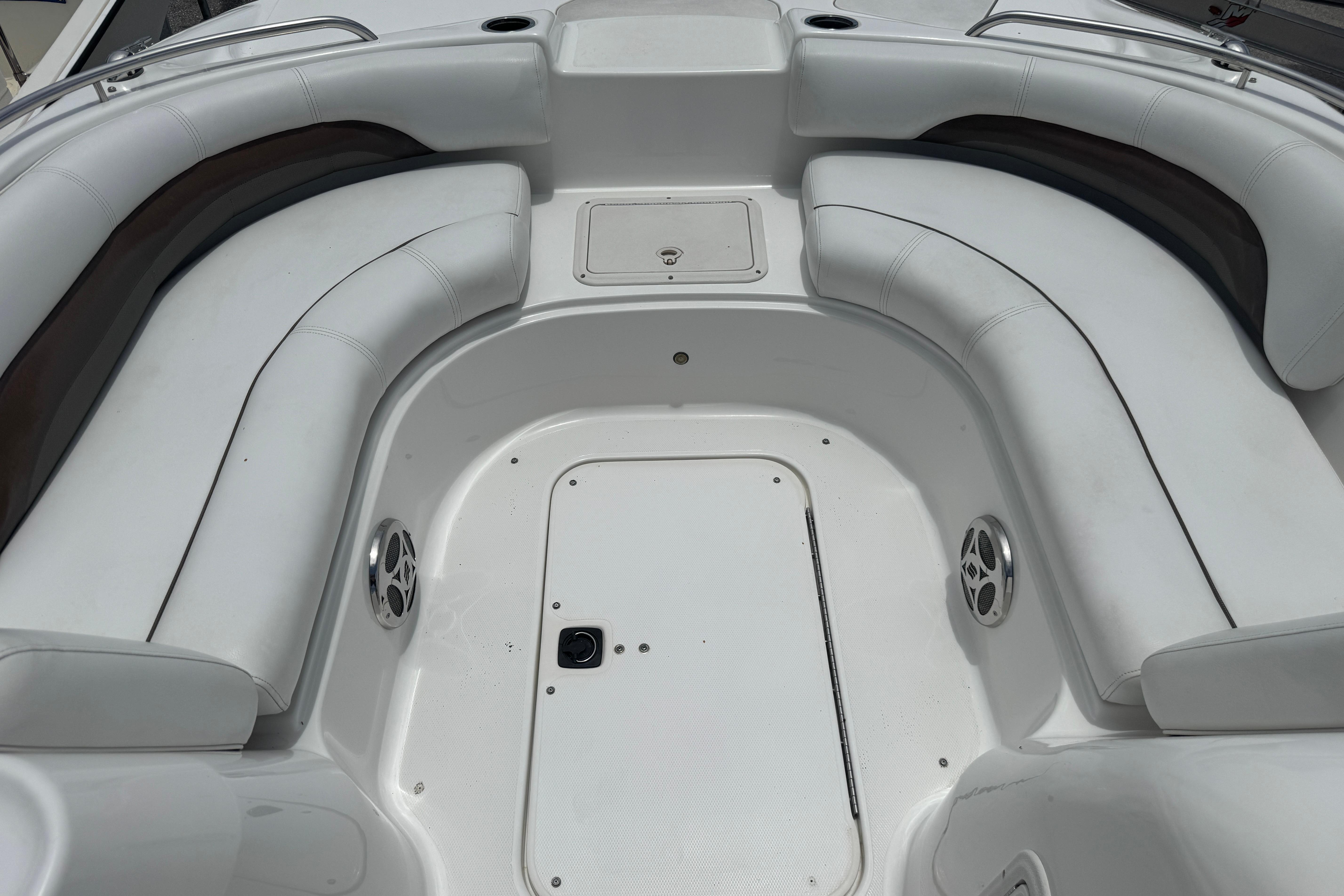 2013 Hurricane SunDeck Sport 188 OB boat interior with white seating and storage compartments.