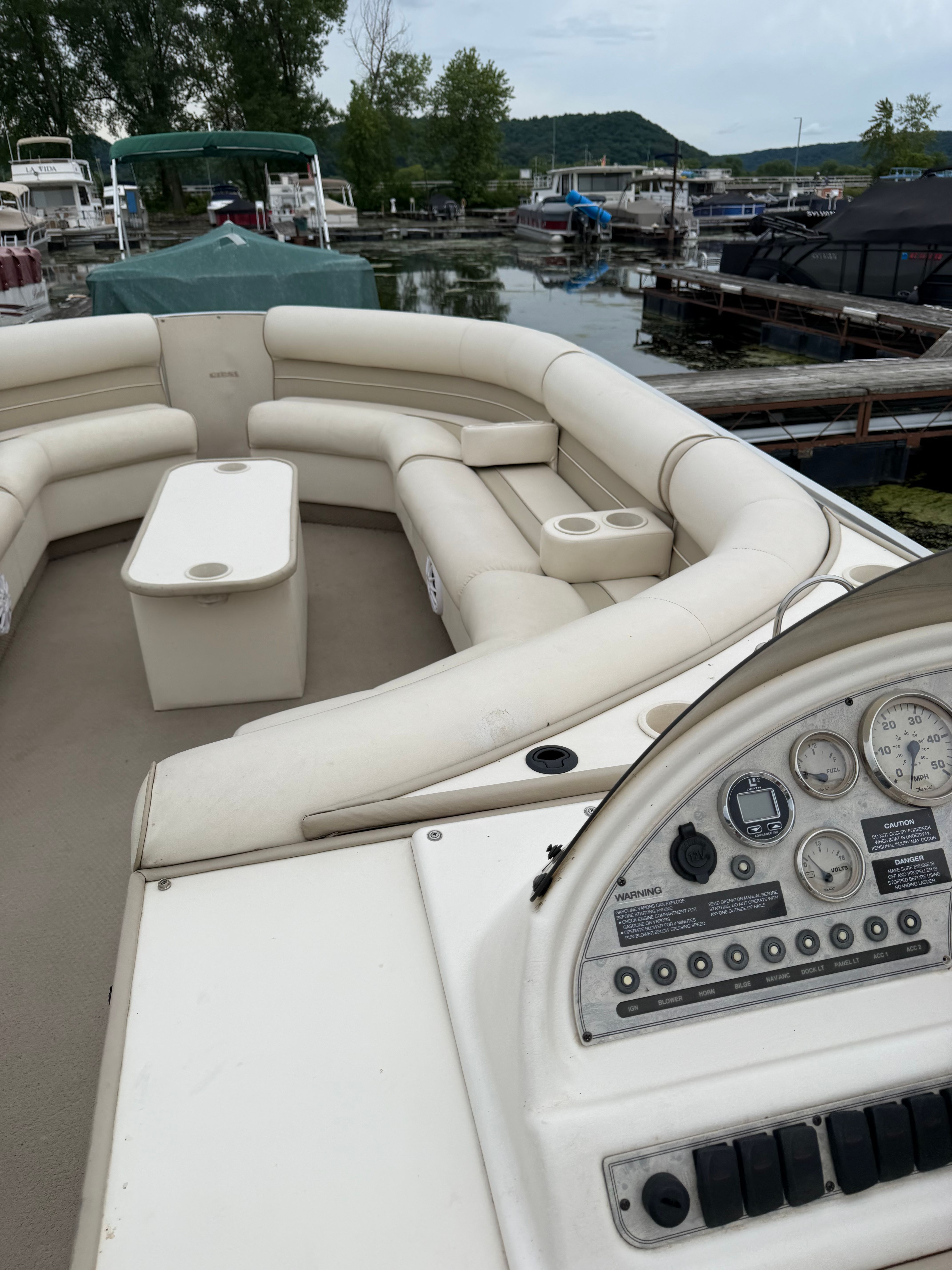 Crest Grand Caribbean 2000: Spacious deck with comfortable seating and helm console at the marina.
