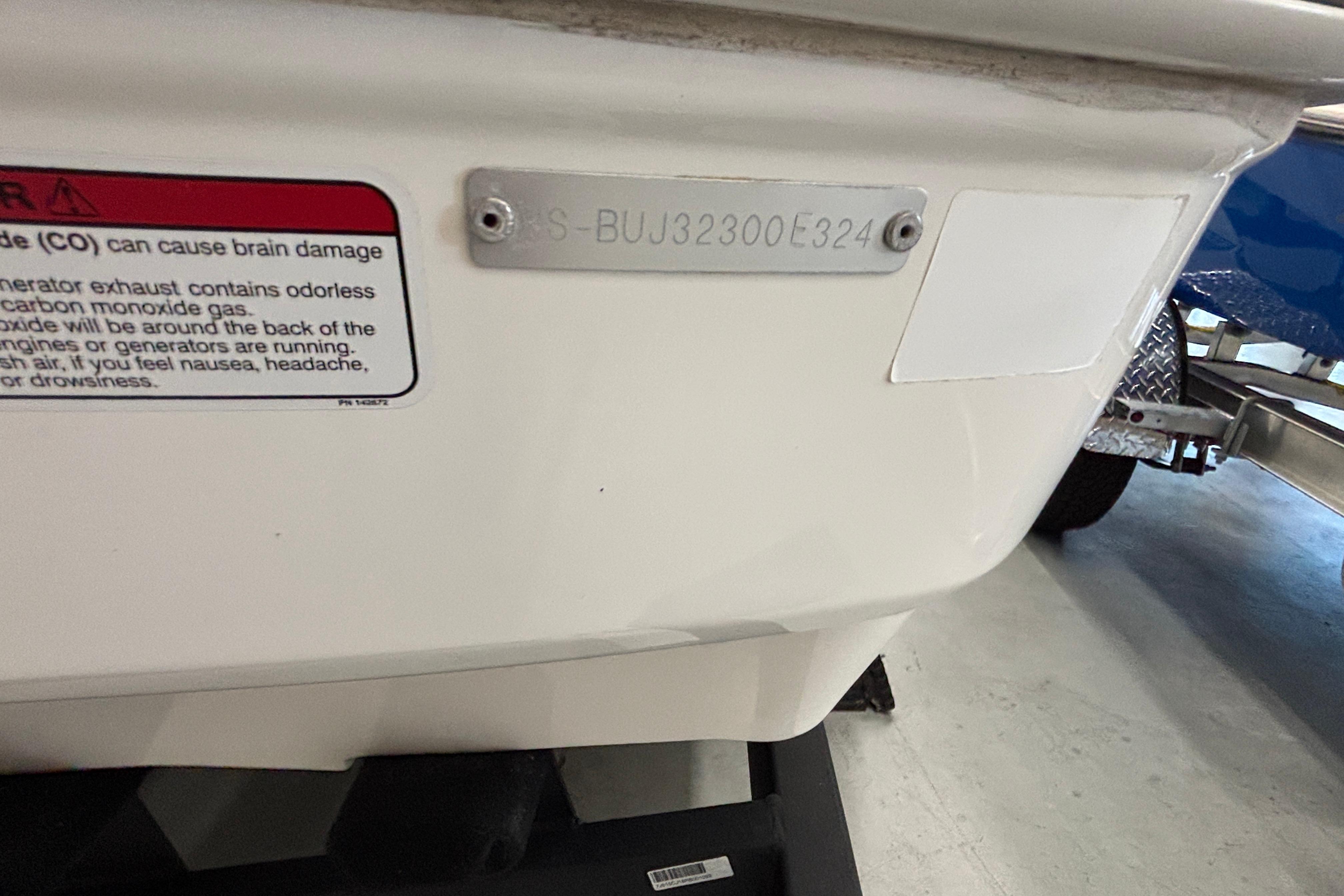 2024 Tahoe T18 boat stern with warning label and identification plate.