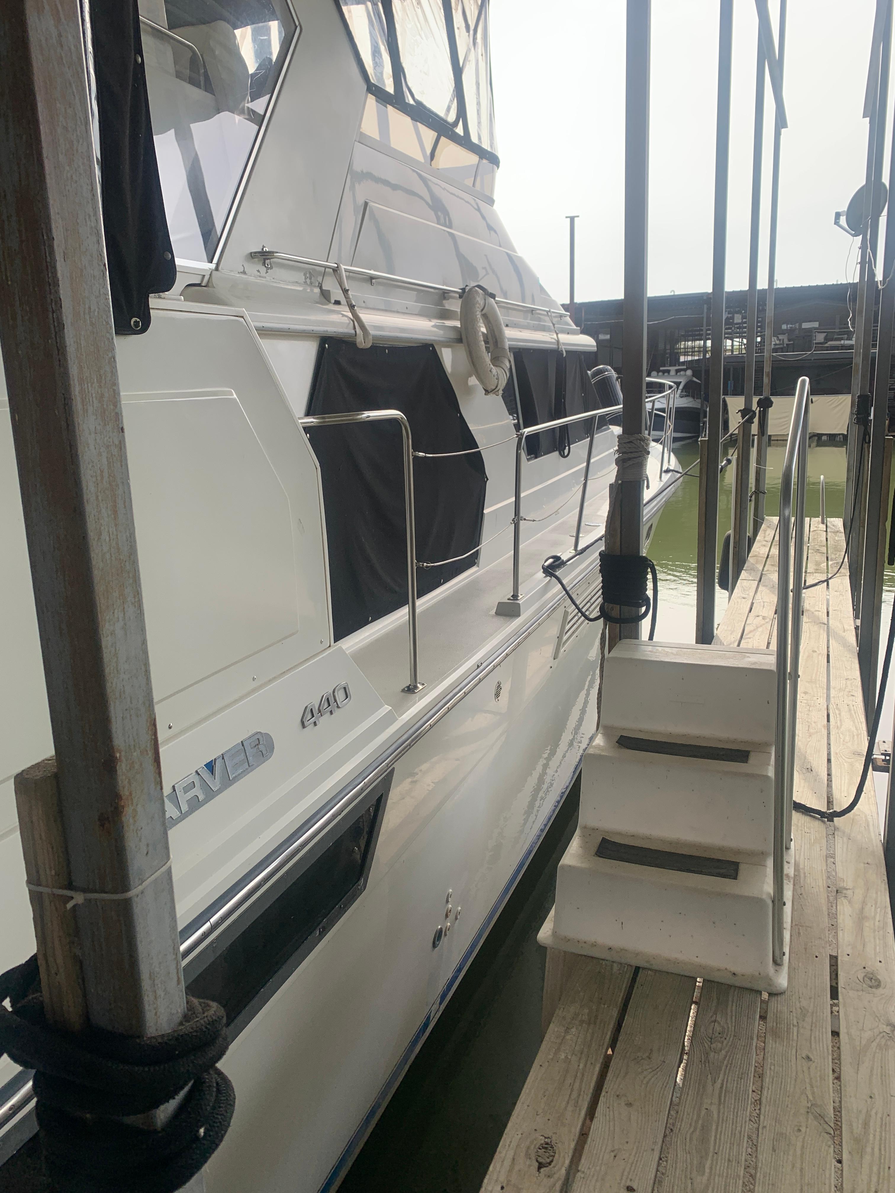 1994 Carver 440 Aft Cabin Motor Yacht docked with boarding steps.