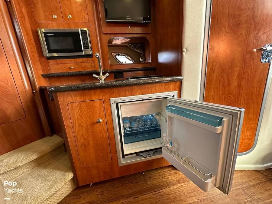 Interior of 2013 Rinker 310 Express Cruiser with kitchenette.