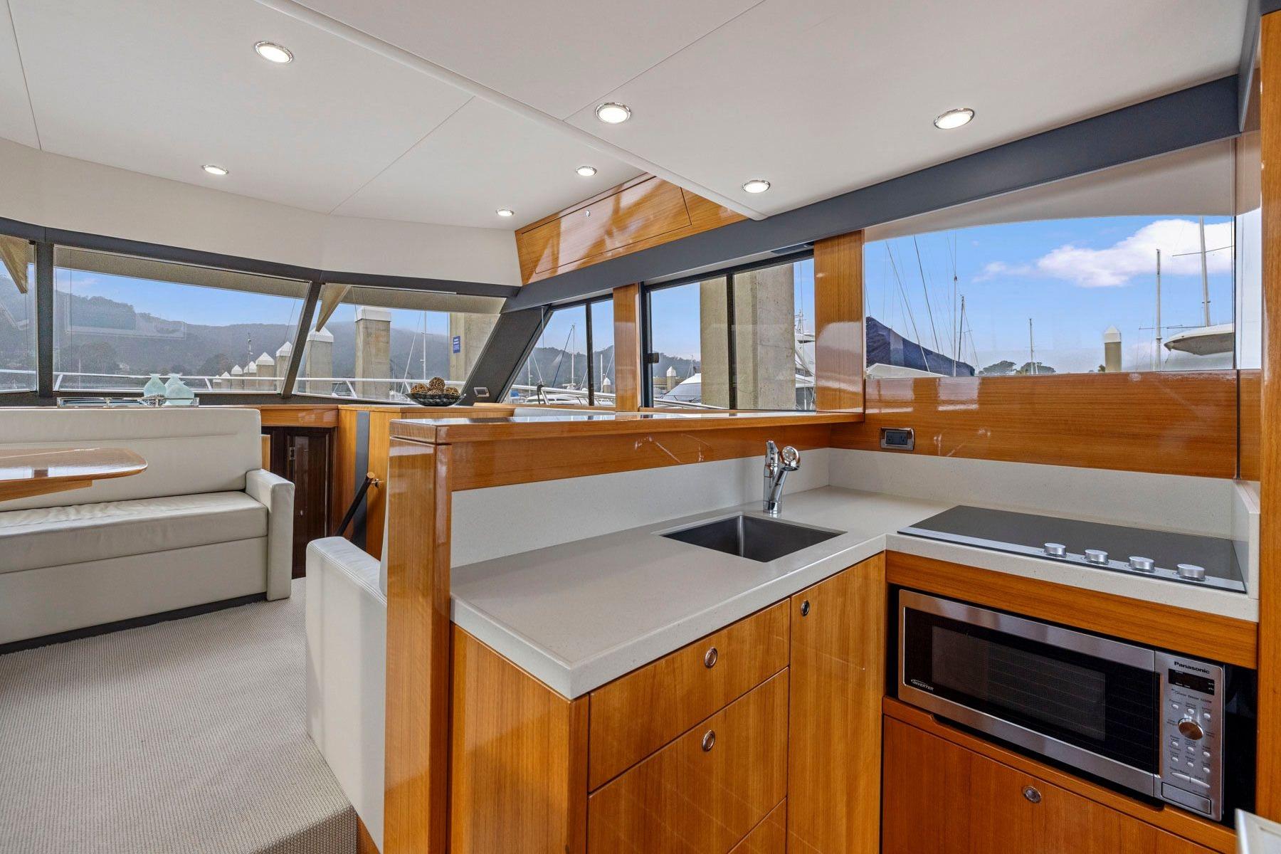 Luxurious interior of 2014 Maritimo M50 yacht with modern kitchen and seating area.