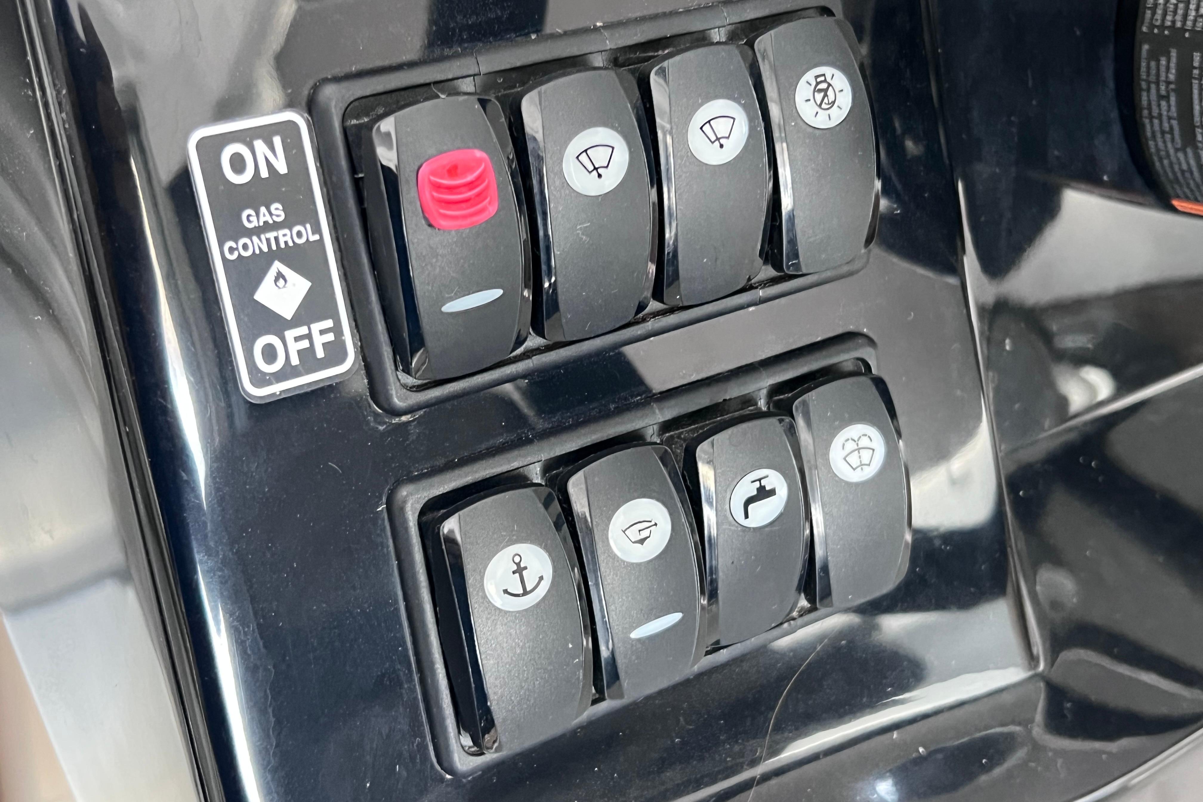 Control panel of 2021 Jeanneau NC Weekender 795 Series 2 with various switches and gas control.