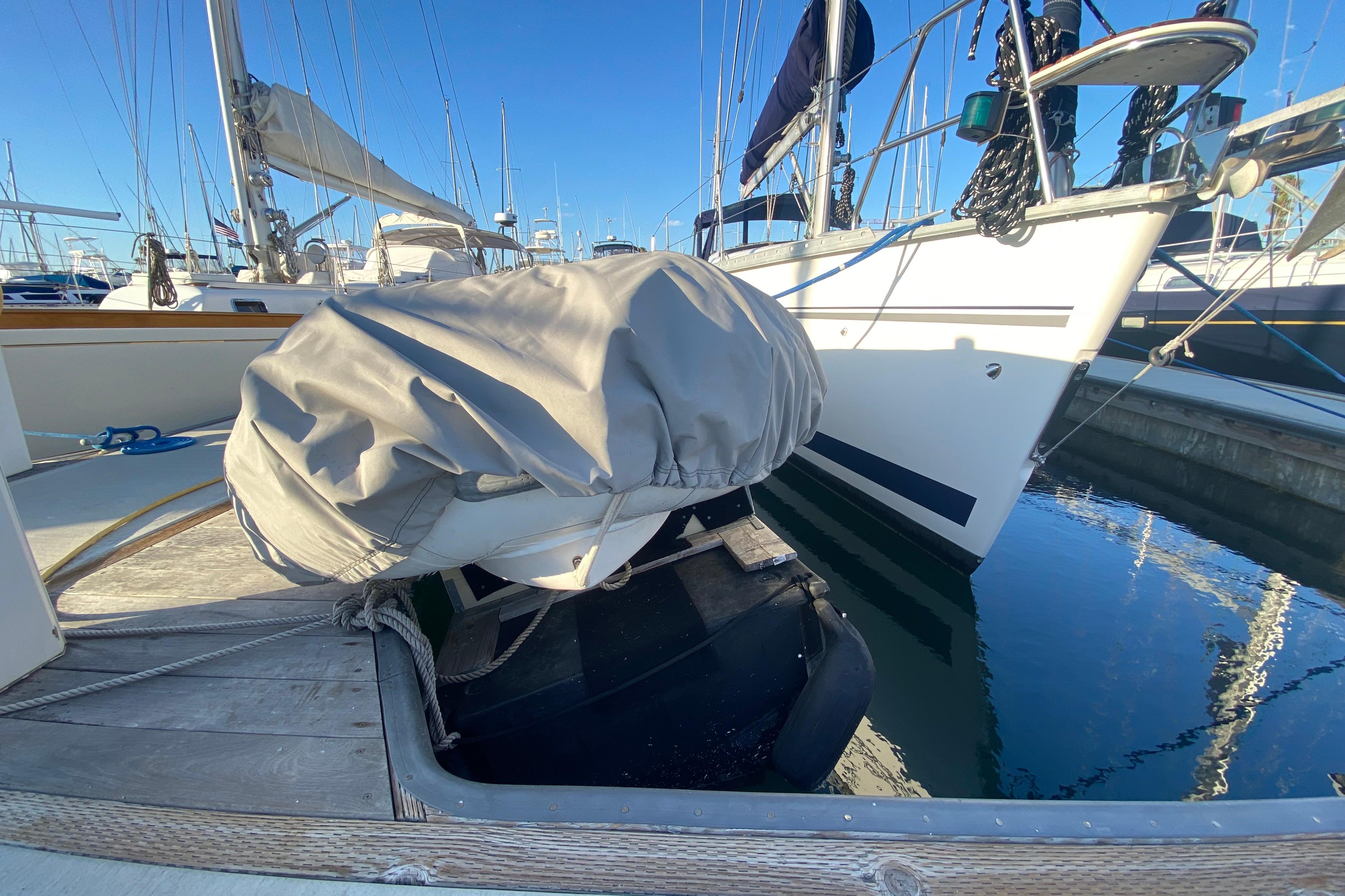 Hunter Legend 40.5 sailboat docked, 1997 model, with covered dinghy on deck.
