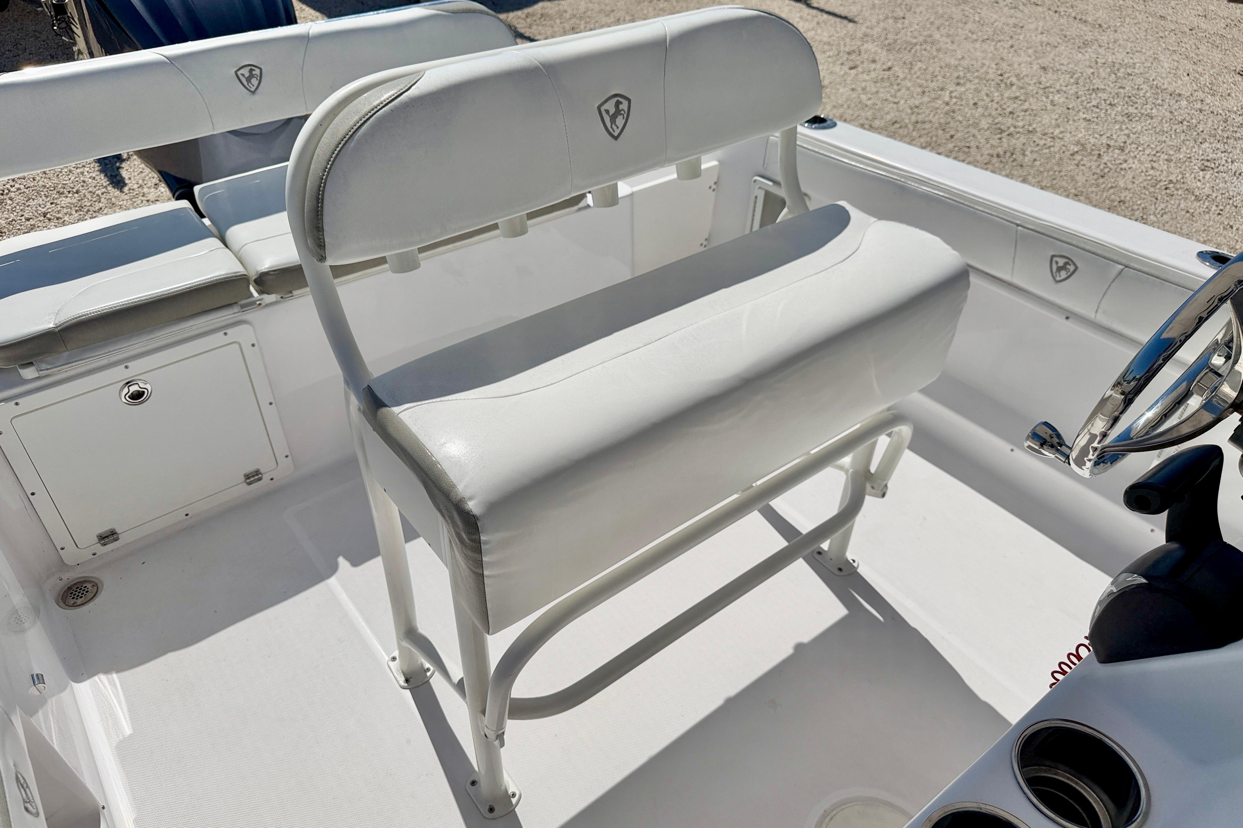 2022 Century 2301 Center Console boat interior with white seating and steering wheel.