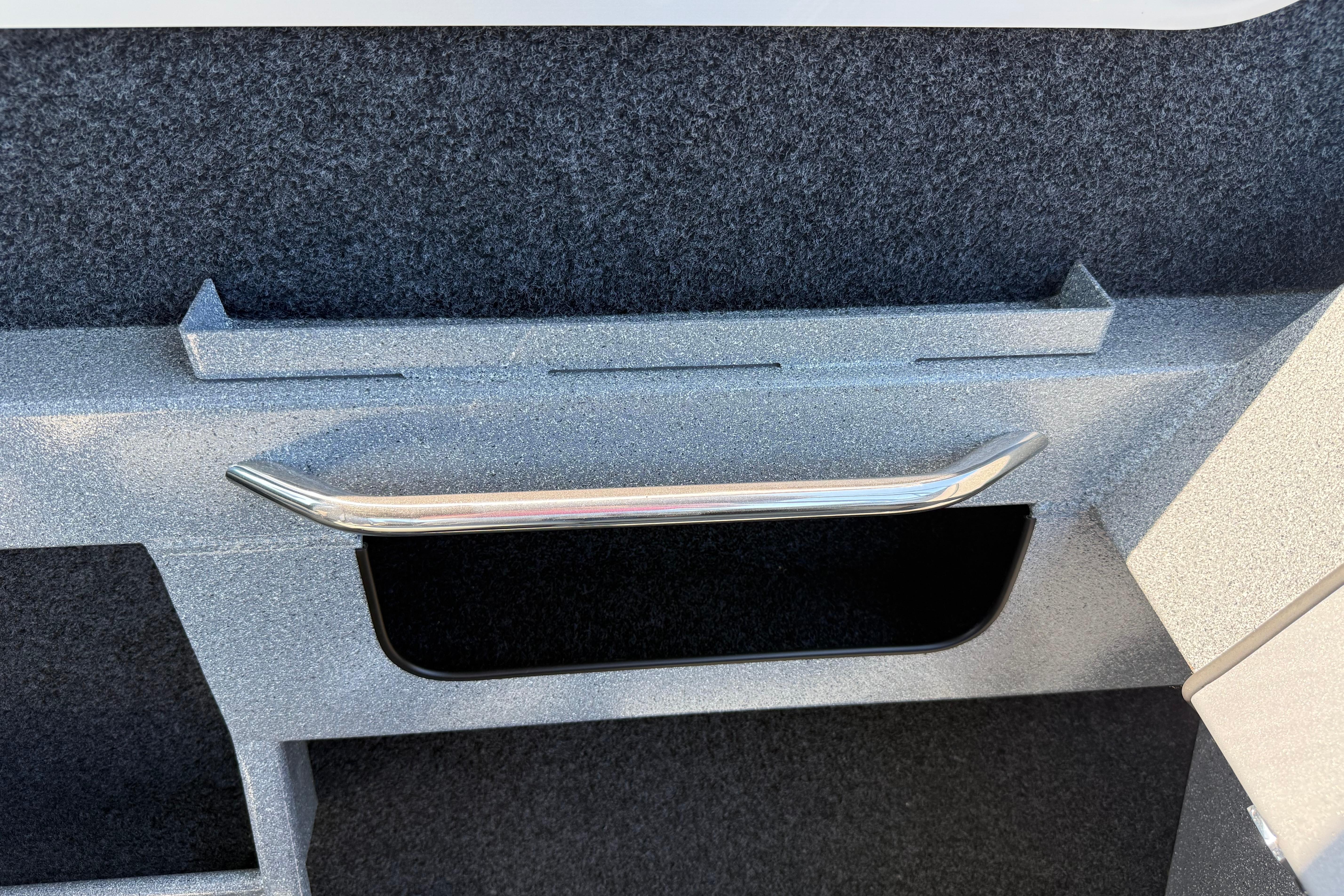 Interior detail of 2025 KingFisher 2225 Escape HT boat, featuring storage compartment and handle.