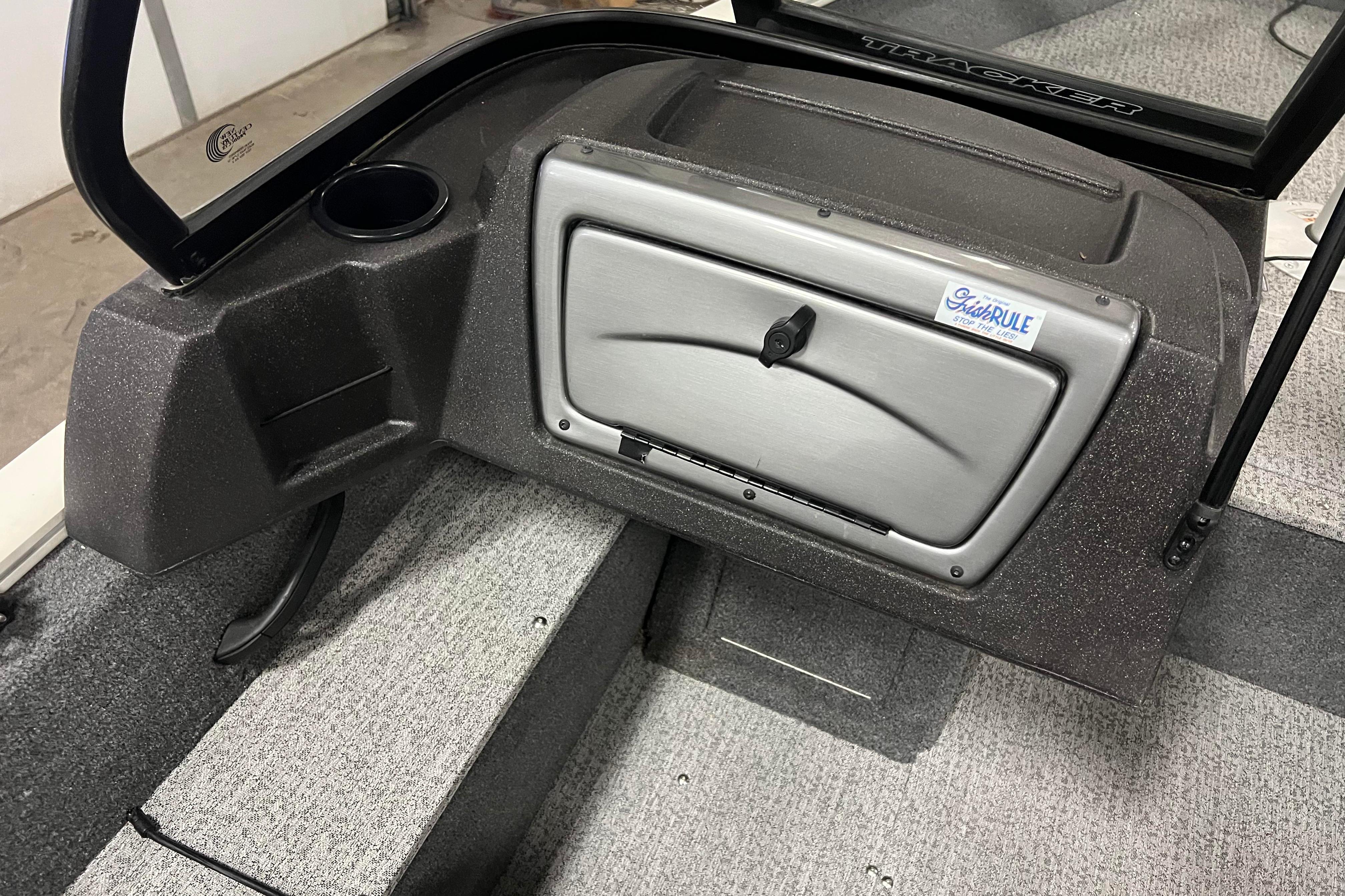 2022 Tracker Pro Guide V-16 WT boat interior with storage compartment and cup holder.