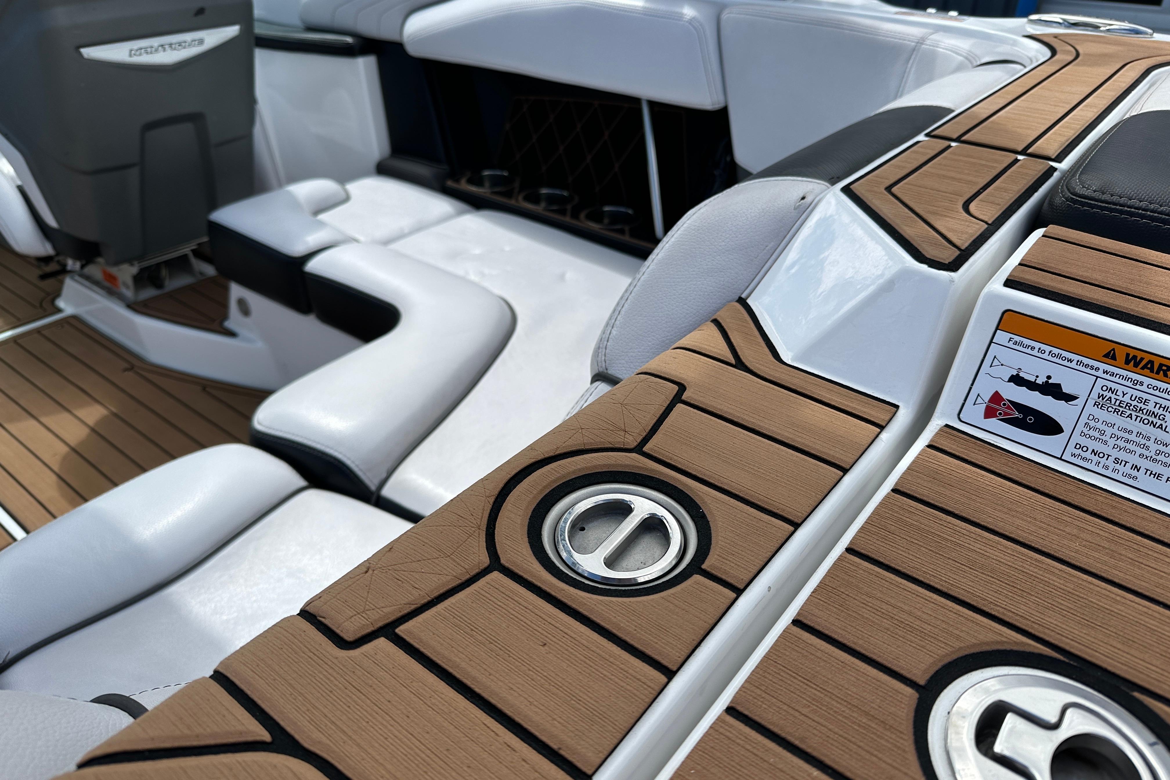 Interior of 2017 Nautique Super Air Nautique GS20 with teak-style flooring and seating.