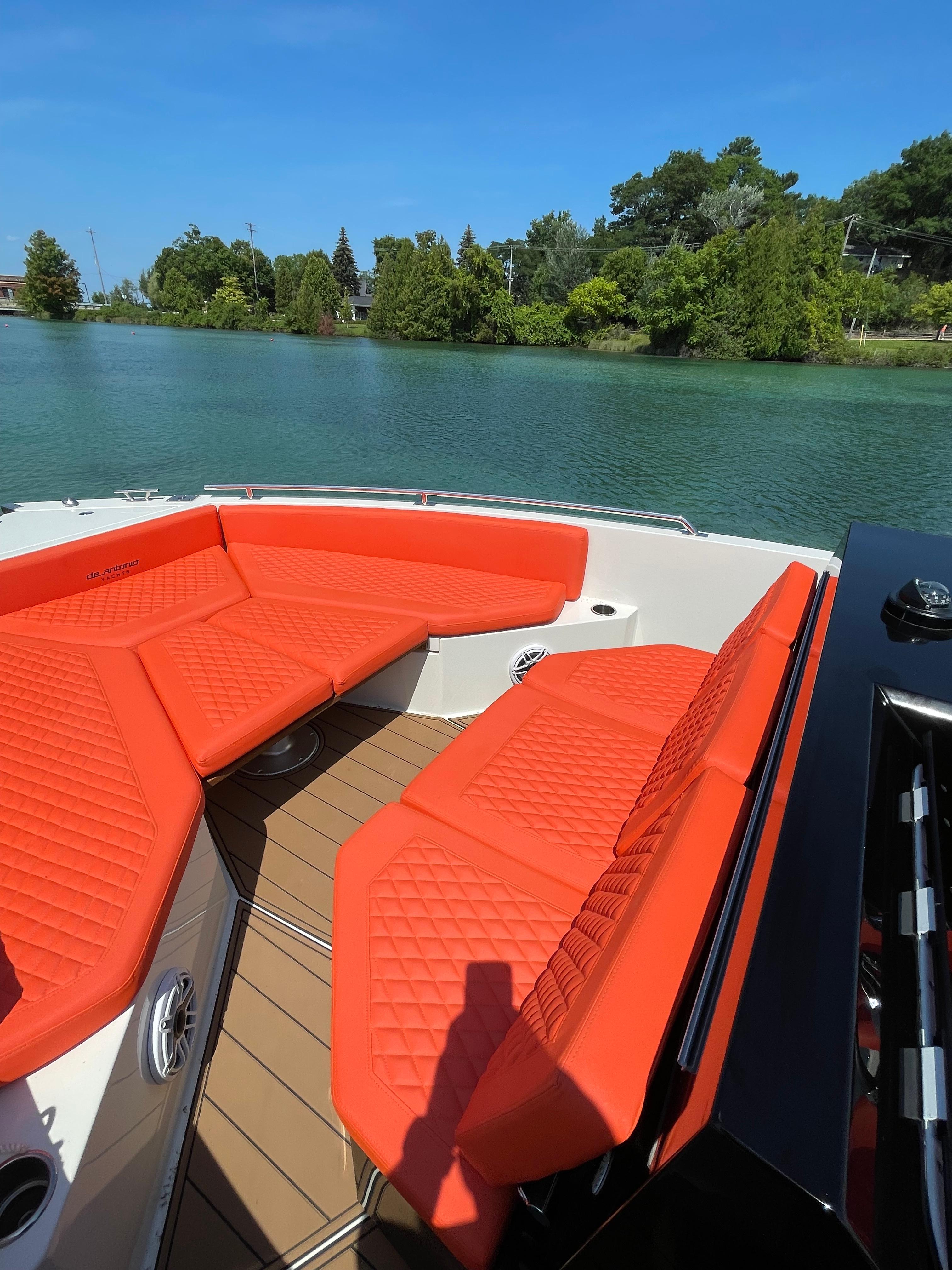 De Antonio Yachts D 28 2020 model with red seating on a serene lake.