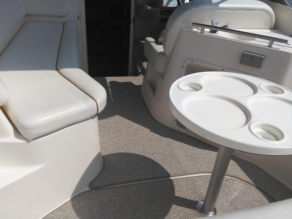 Interior of a 2004 Rinker Fiesta Vee 250 boat with seating area and table.