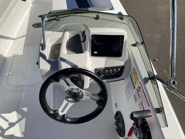 2025 Tahoe T18 boat dashboard with steering wheel and control panel.
