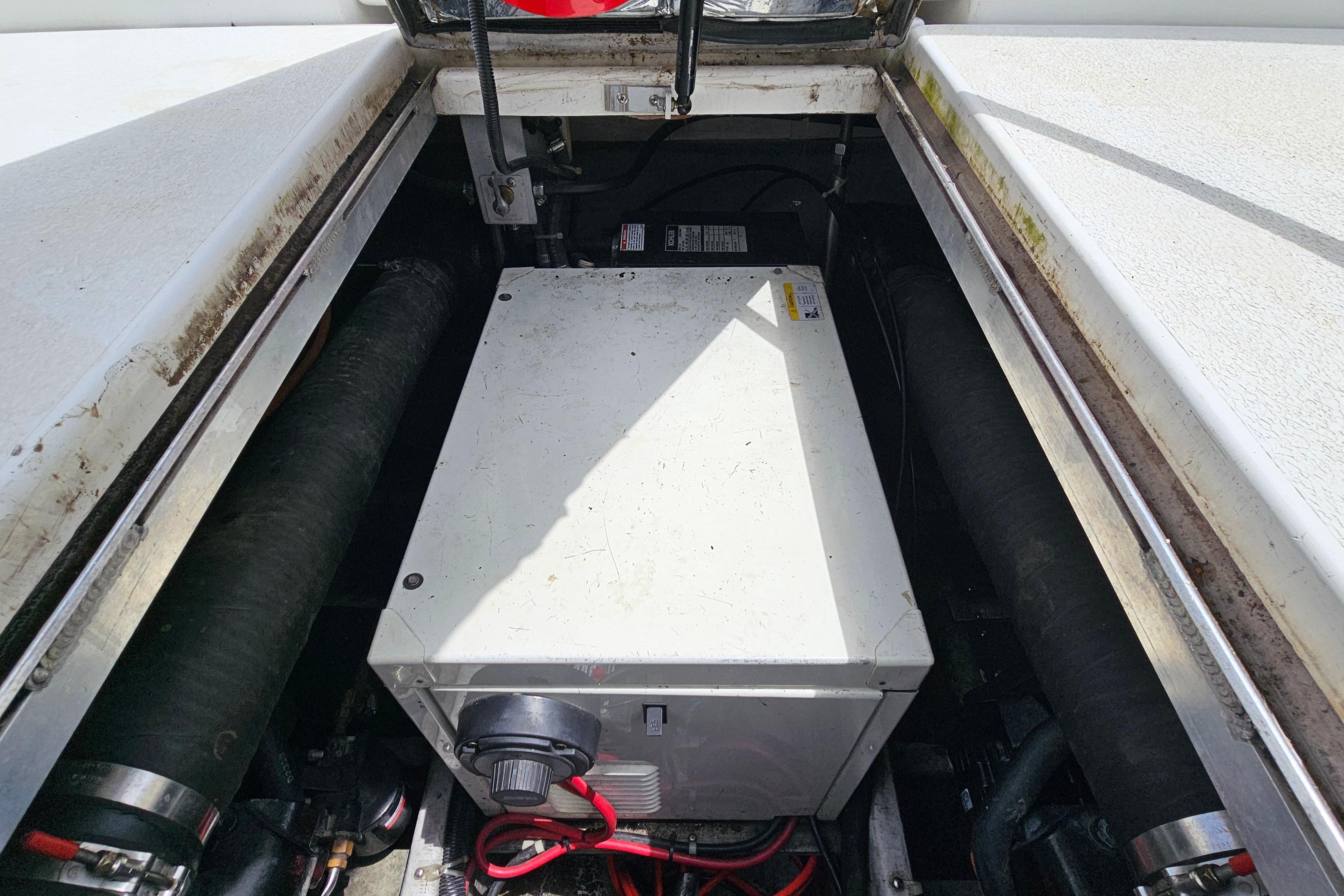 Engine compartment of a 1999 Carver 350 Mariner boat, showing mechanical components.