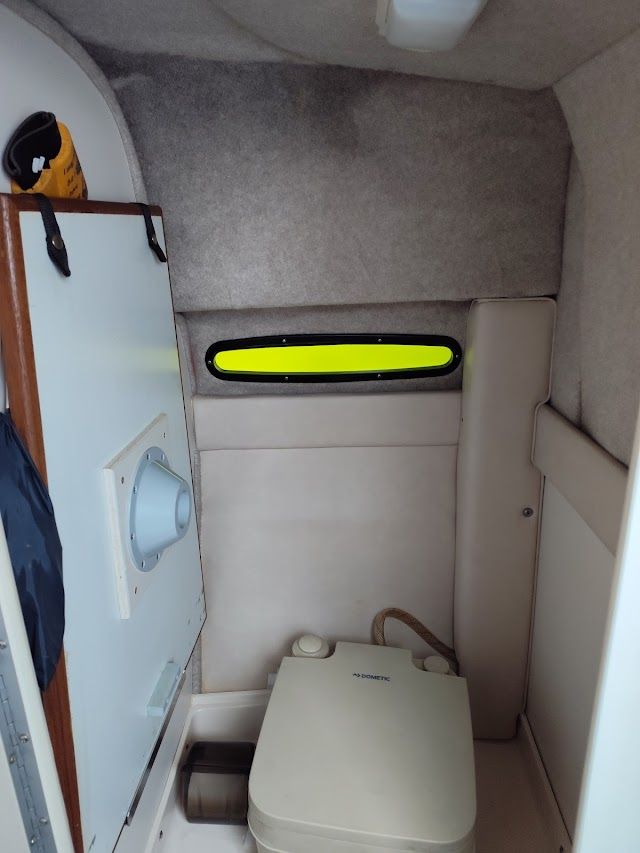 Interior of a 1994 Sea Ray 230 Sundancer with toilet.