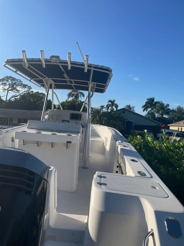 2002 Edgewater 260 Center Console boat with T-top in a residential area.