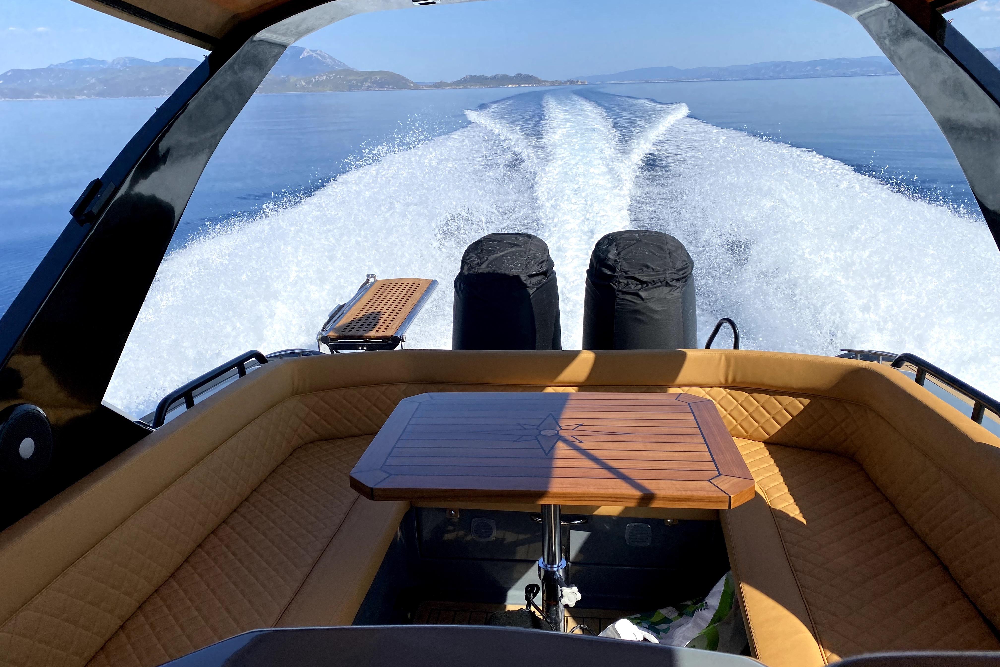 2024 Salpa SOLEIL 33 boat cruising on open water, featuring luxurious seating and wooden table.